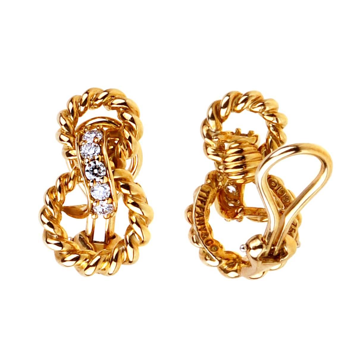 A fabulous pair of Tiffany & Co earrings circa 1990's featuring a braided 18k yellow gold design accompanied with 10 of the finest Tiffany & Co round brilliant cut diamonds. The earrings measure .75