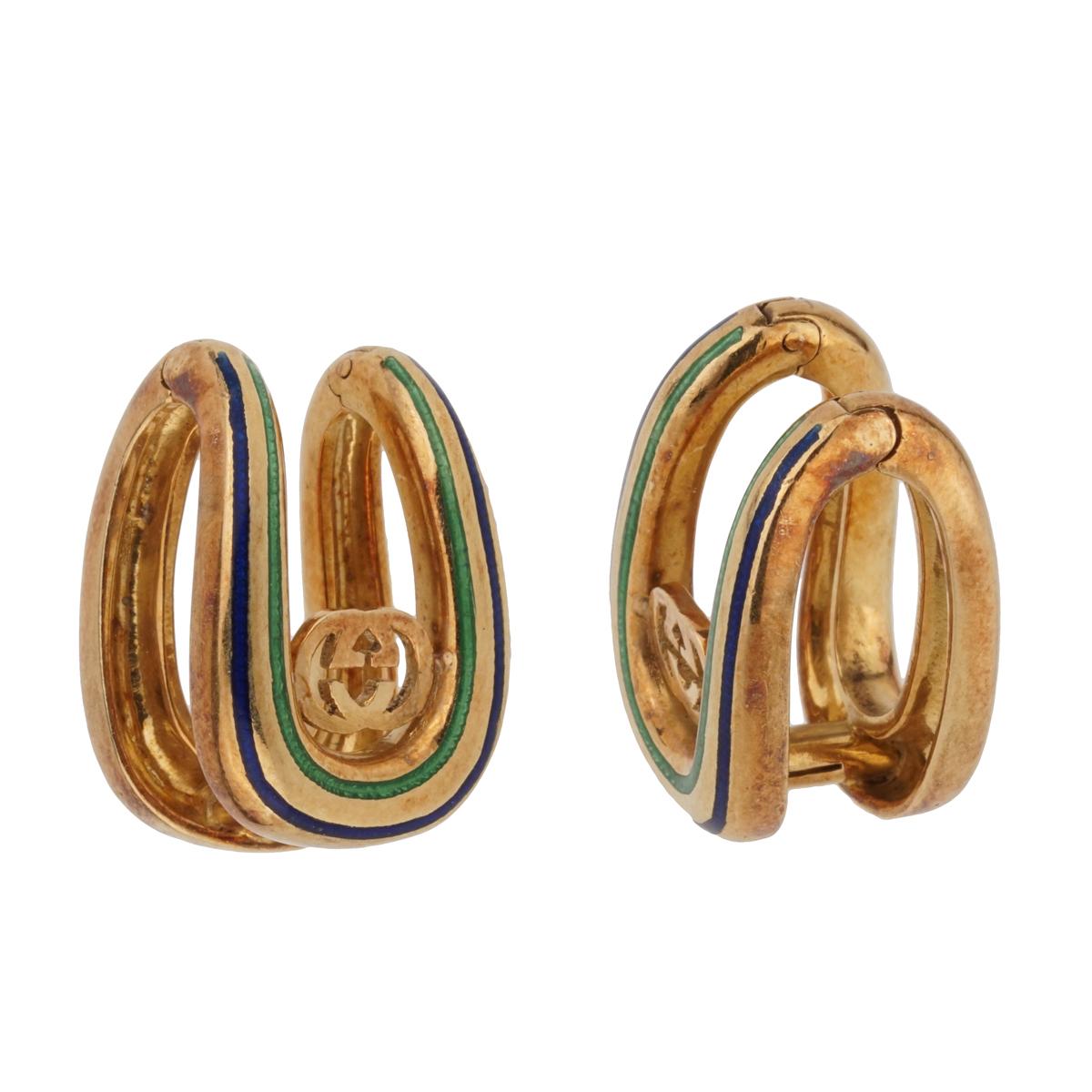 An amazing pair of vintage Gucci cuff links circa 1970's laced with blue and green enamel and the iconic double G motif in 18k yellow gold. The earrings are in original condition, and have not been polished in order to maintain the lovely patina.