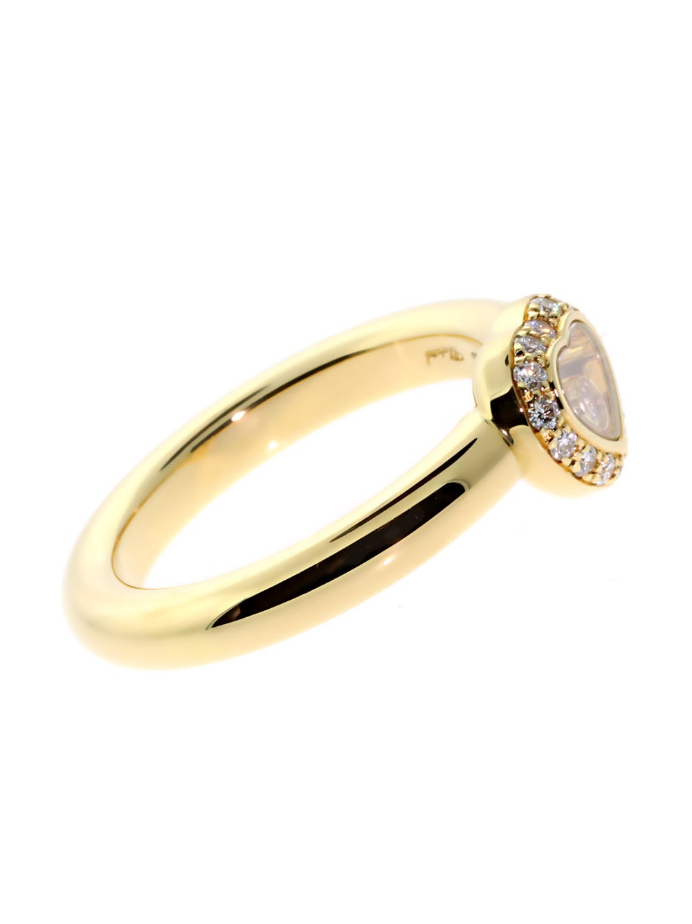 This enchanting 18k Yellow Gold Chopard Ring hits all the right notes and confirms once again why the Happy Diamonds line is so beloved around the world! Vs1 E-F Color Diamonds line the Heart-shaped Motif, which features a transparent core that