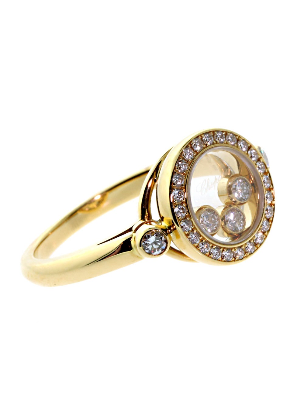 Majestic Diamonds appear in 3 separate areas of this glorious Happy Diamonds Ring from Chopard: within the transparent core, set into a circle around the core, and set into the 18k Yellow Gold Band on either side of the Crown.

Made of 18k Yellow