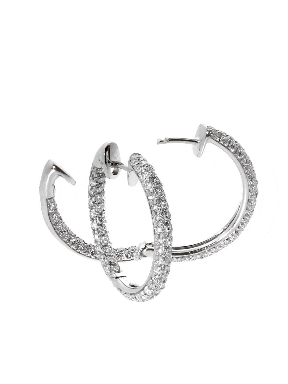 A plethora of diamonds set in these 18k White Gold diamond hoop earrings by Harry Winston. The earrings are set with appx 2.5ct of Round Brilliant Cut diamond, and have a diameter of 23mm (.90