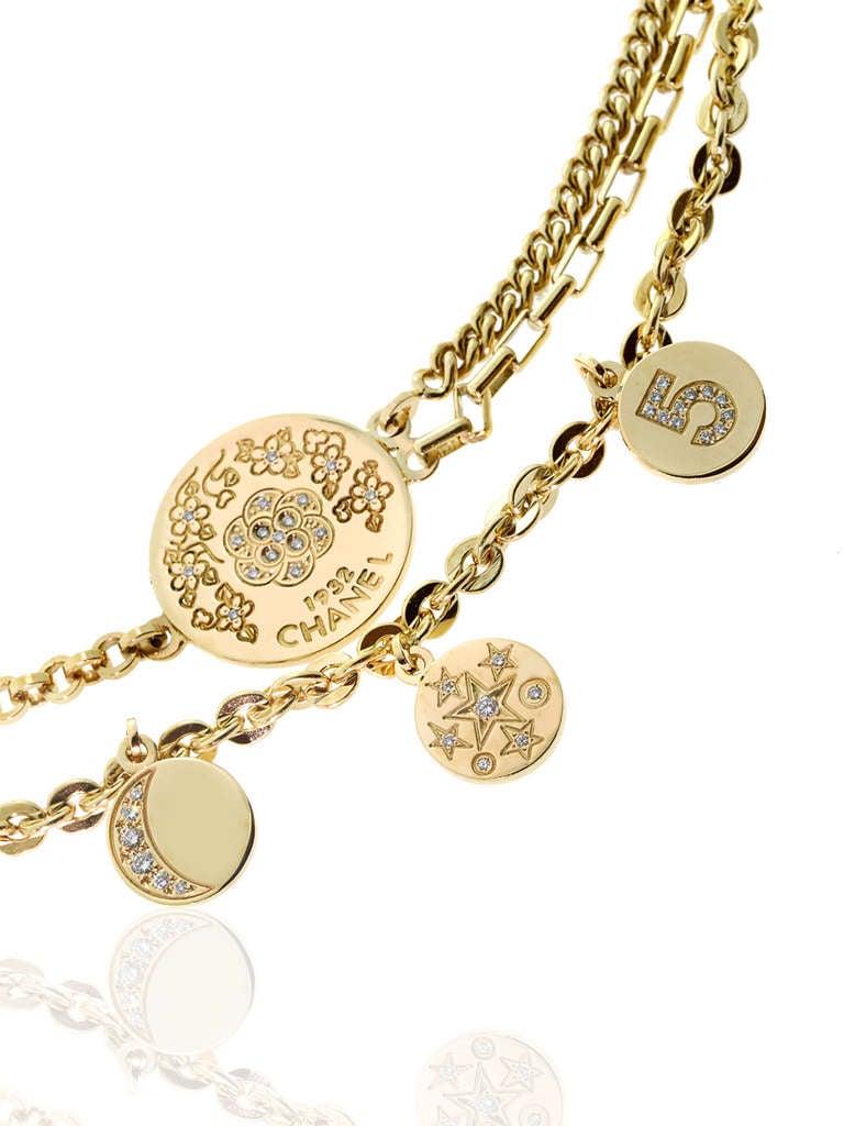 This stunning and playful charm bracelet by Chanel, features the Comete Collection as well as the infamous Camellia Collection to bring a playful and sophisticated look together. Adorned with Vvs1 E Color Round Brilliant Cut Diamonds, crafted in 18k