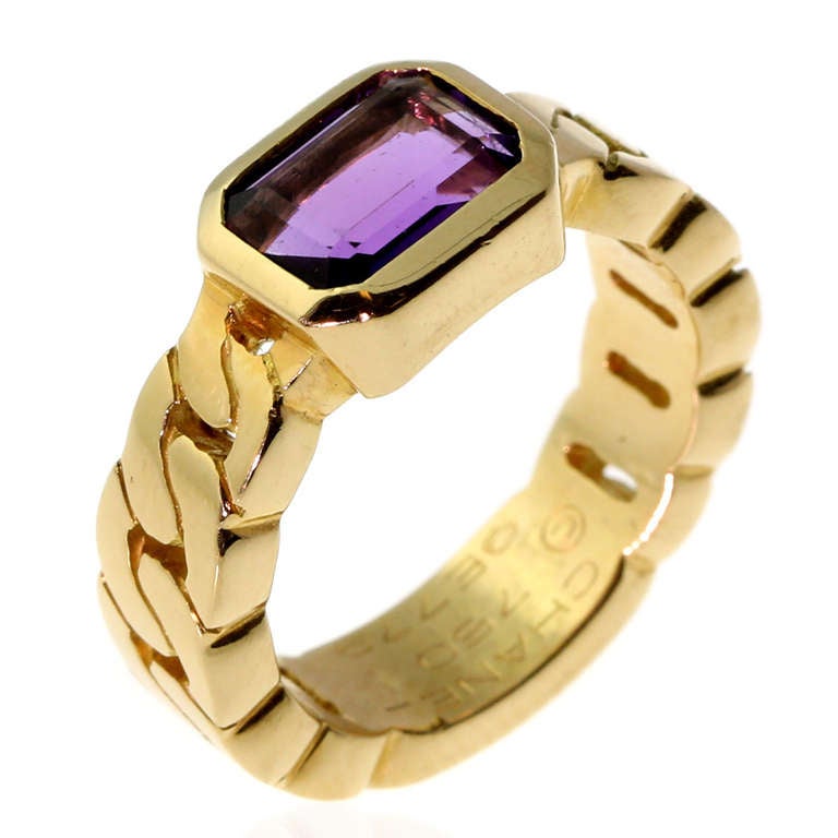 This bold and stunning ring by Chanel features an Amethyst crafted in 18k Yellow Gold. The ring measures 8mm wide tapering down to 5.5mm, Sz 5 1/2, and weighs 9.6 grams.