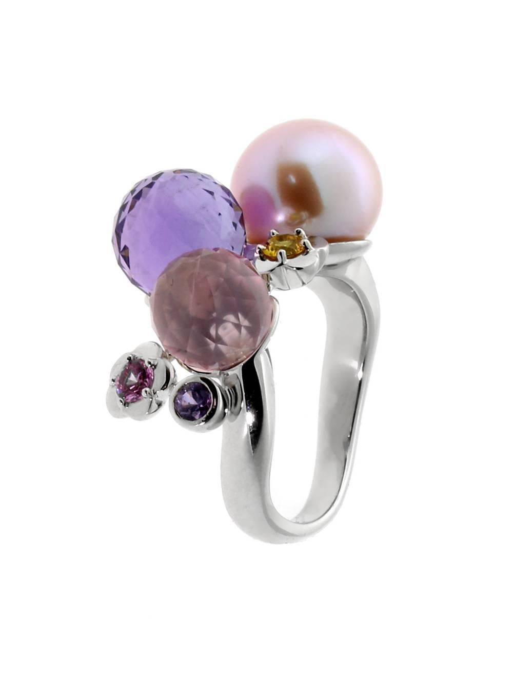 A chic Chanel cocktail ring featuring an eclectic blend of Pearl, Amethyst, Pink & Yellow Sapphire, Tourmaline set in 18k white gold.

Size: US 5 1/2
Dimensions: .62″ Inches wide

Inventory ID: 0000036