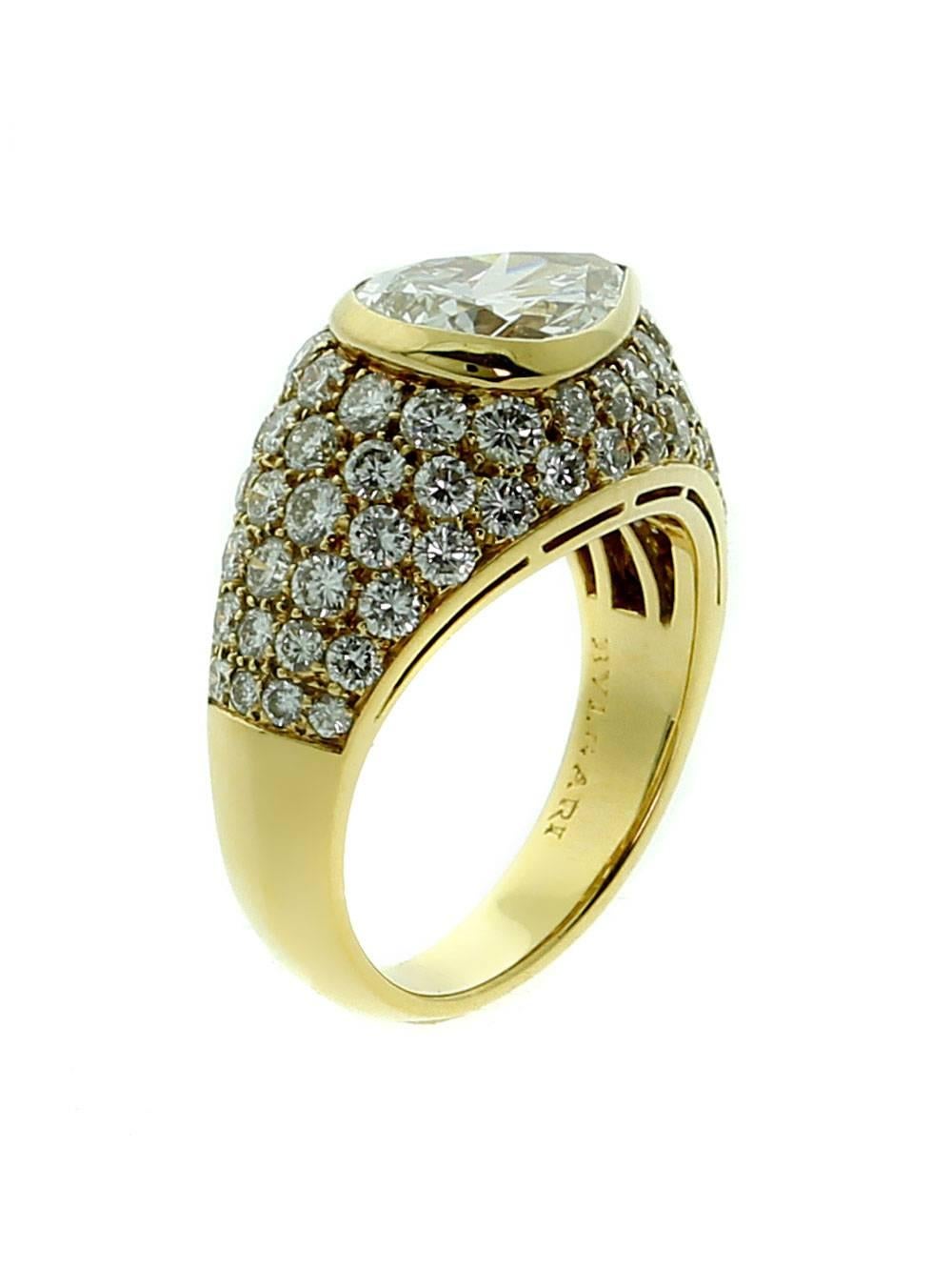 A fabulous authentic Bulgari diamond cocktail ring showcasing a 1.73ct pear shape diamond surrounded by an abundance of round brilliant cut diamonds set in 18k yellow gold.

Size: US 5 ( Resizeable)
Dimensions: 11mm wide (.43″ wide)

Inventory