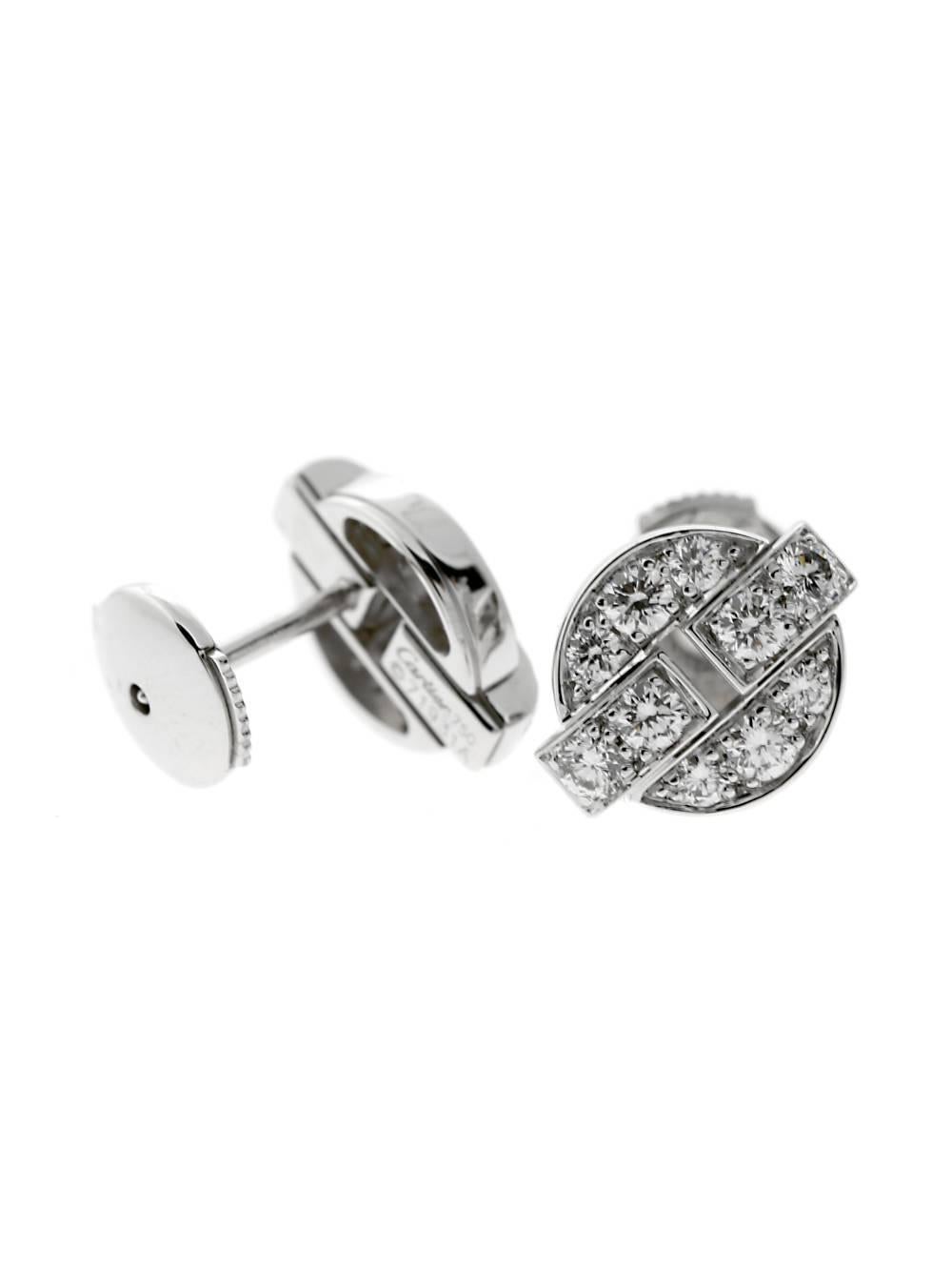 A classic pair of Cartier diamond stud earrings adorned with Vs quality diamonds set in 18k white gold. The earrings measure (.35