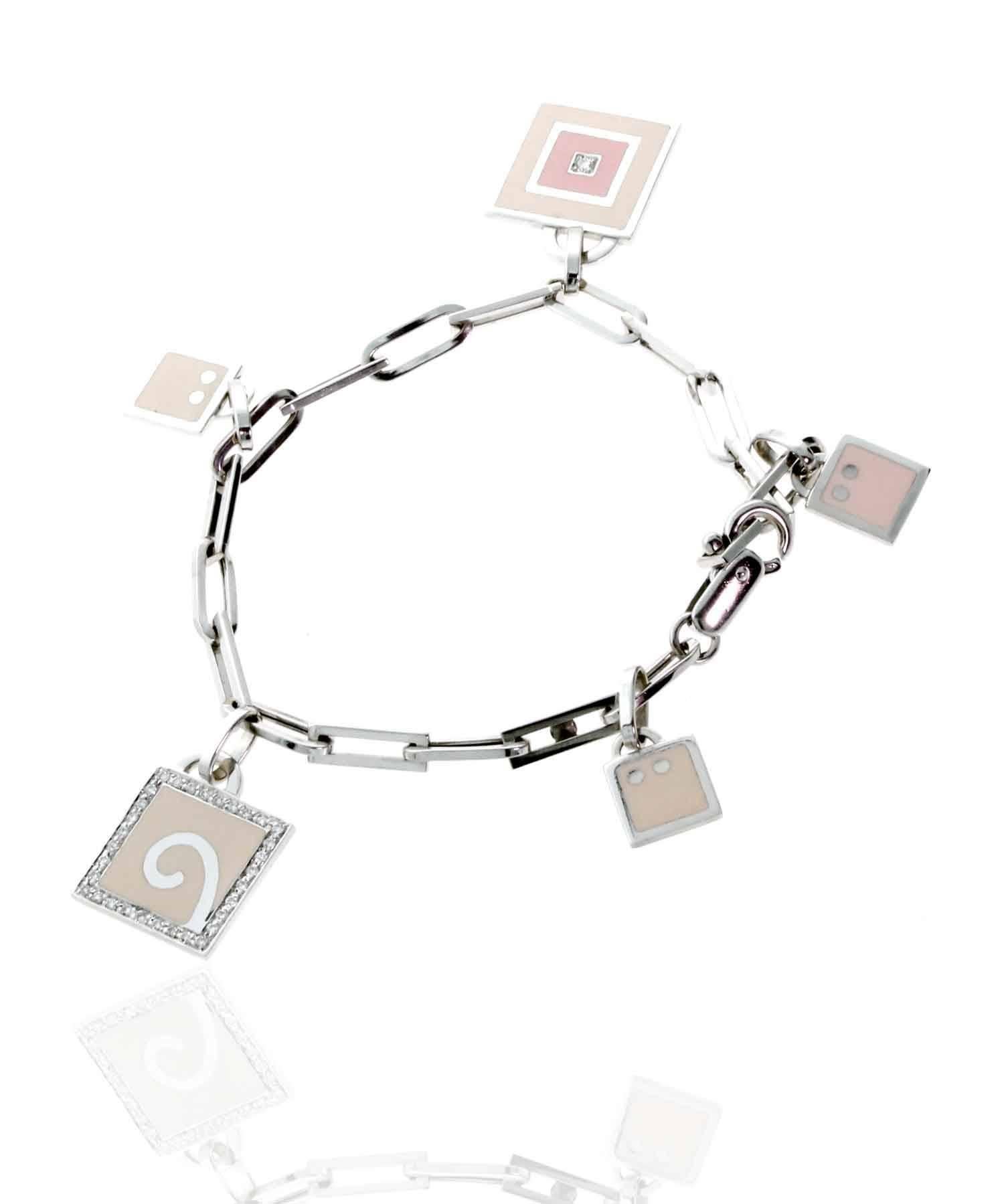 A stunning 18k white gold charm bracelet by La Nouvelle Bague. Each of its 5 beautiful charms has a distinct design and unique patern.

Length: Upto 7 1/4″

Diamonds: Round Brilliant Cut Diamonds .44Ct Total Diamond Weight
Weight: 17.7