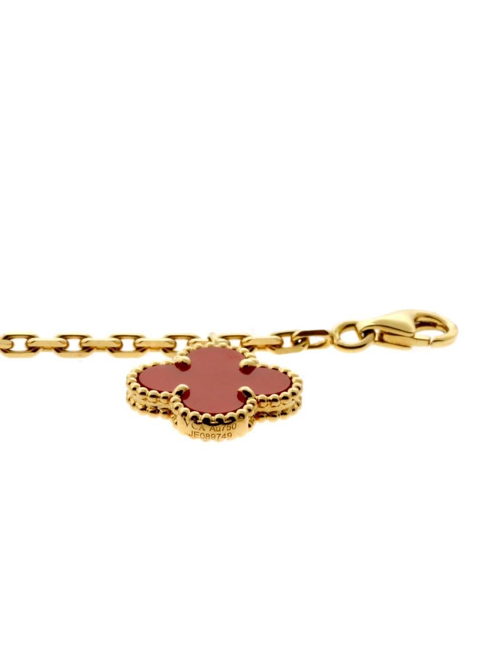 Van Cleef & Arpels bracelet in 18k yellow gold features the classic Alhambra motif. Three carnelian and two tiger-eye stones drape along the wrist charm-like.

Bracelet Length: 7 3/4