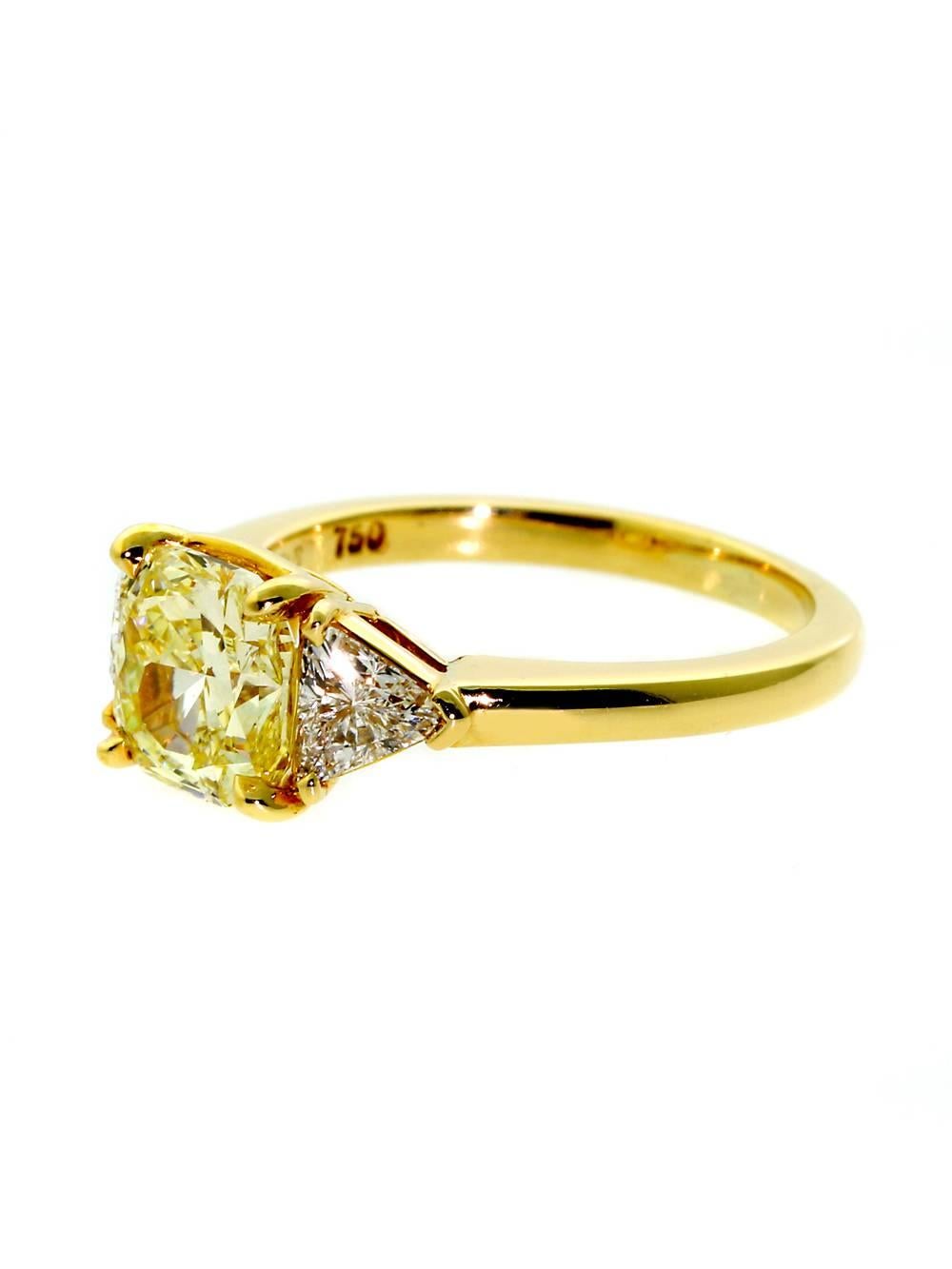 The magnificent centerpiece of this Ring is its 2.10 ct Starburst Cut Vvs1 Fancy Intense Yellow Diamond, symmetrically flanked by .70 ct of matching Vvs2 E-F Color Trillion Cut Diamonds. 

Size: 6 1/2 (Resizeable)

Accessories: Cartier Gift Box,