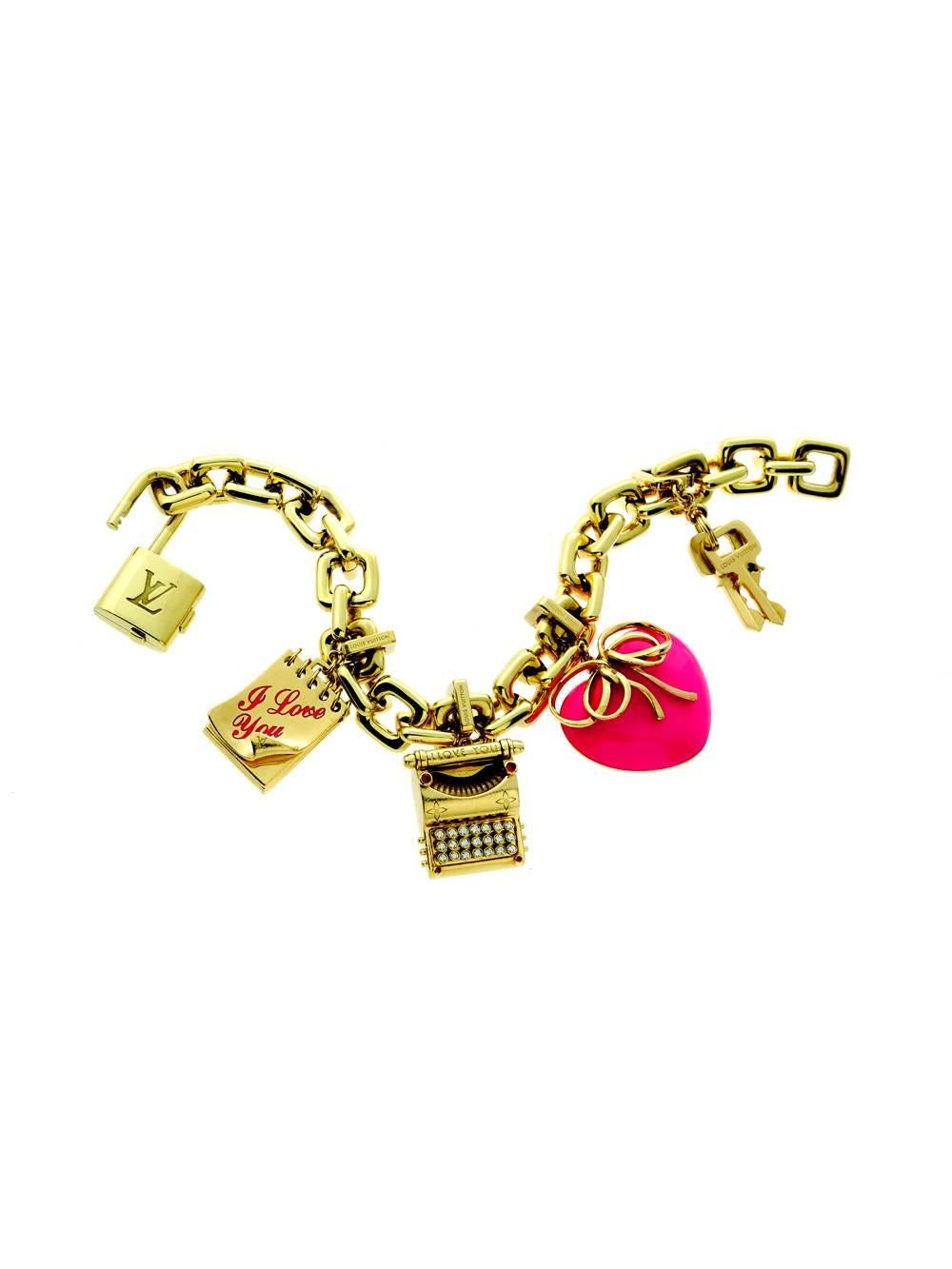 An elegant Louis Vuitton Padlock & Keys Bracelet featuring a diamond typewriter charm, pink enamel heart, and an I Love You notepad. The perfect bracelet to show your creative side in yellow gold tones make it the perfect complement to almost