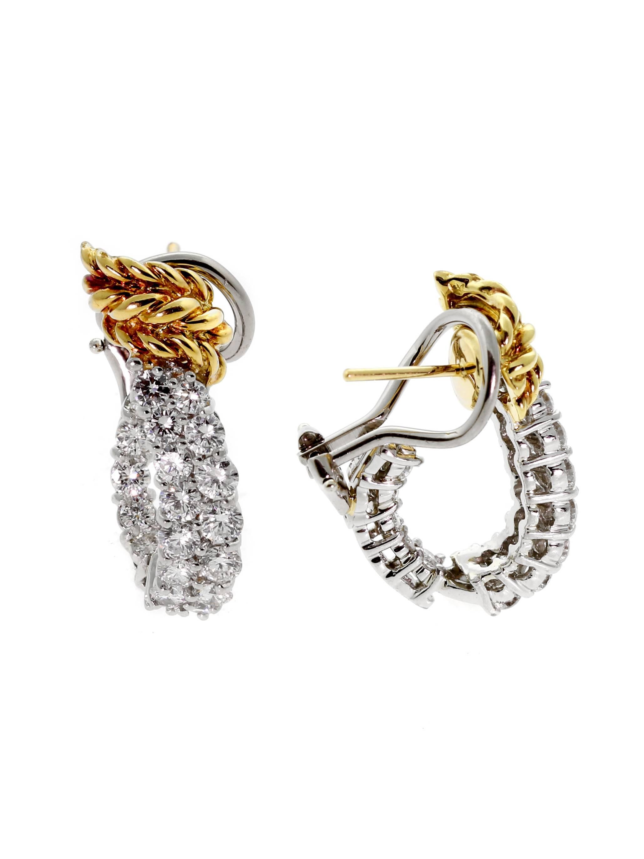 Tiffany & Co Schlumberger diamond earrings adorned with round brilliant cut diamonds set in Platinum and touched with 18k yellow gold. The earrings measure 1" in length.

Inventory ID: 0000369