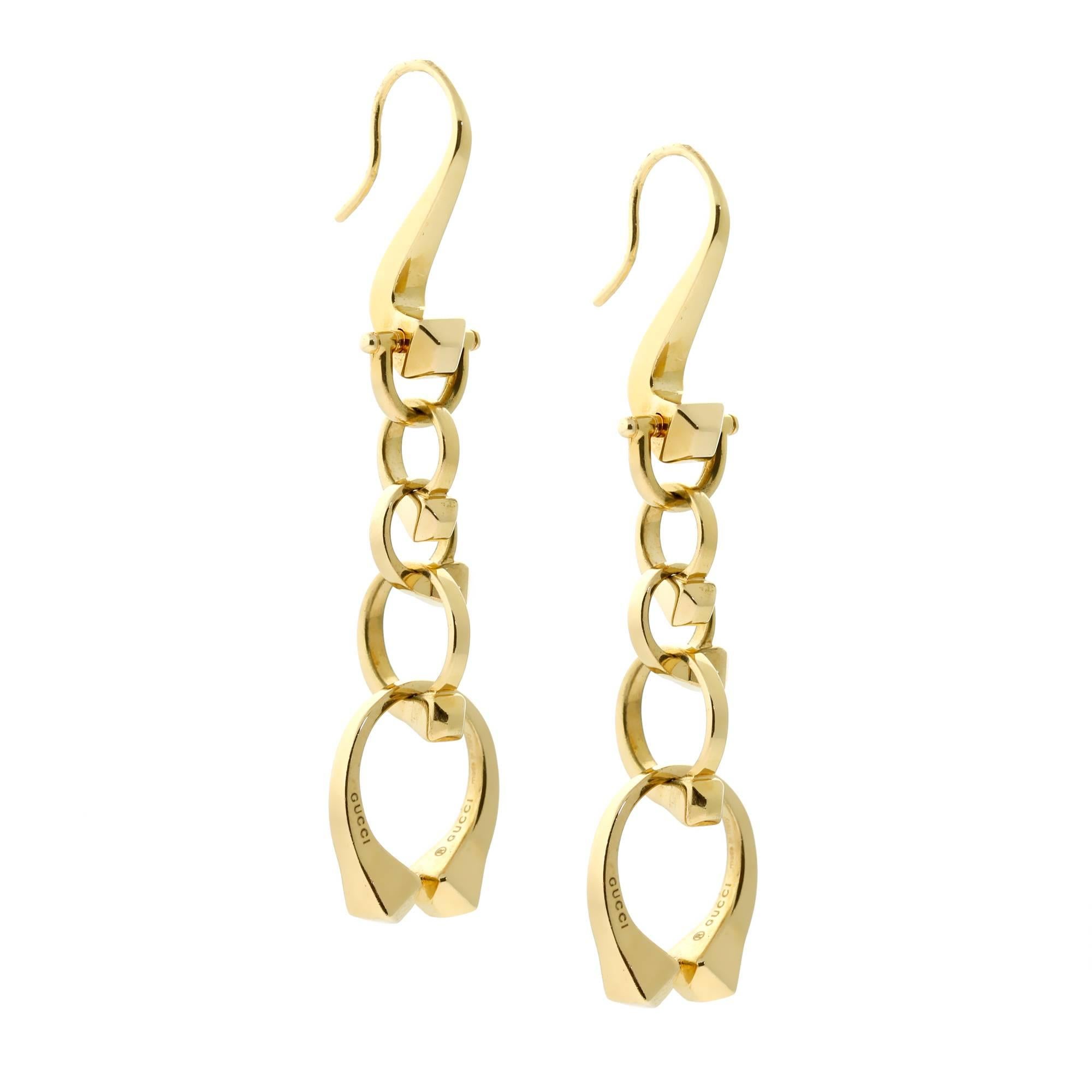 A chic pair of Gucci earrings featuring articulating Nail motifs crafted in 18k yellow gold. Earring Length: 1.25