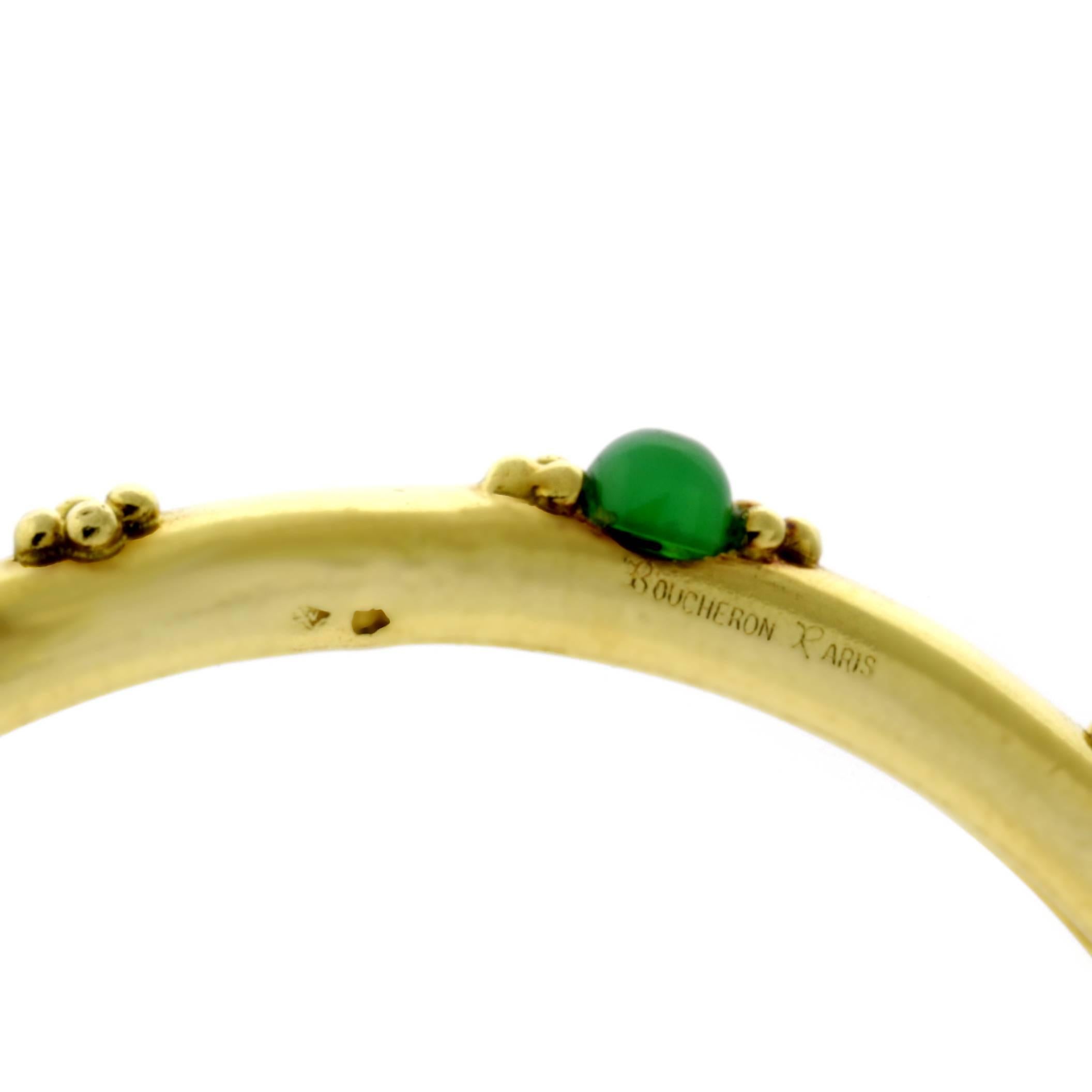 A classic 18k yellow gold bangle by Boucheron featuring 6 cabochon emeralds. The bracelets internal diameter is 2.25