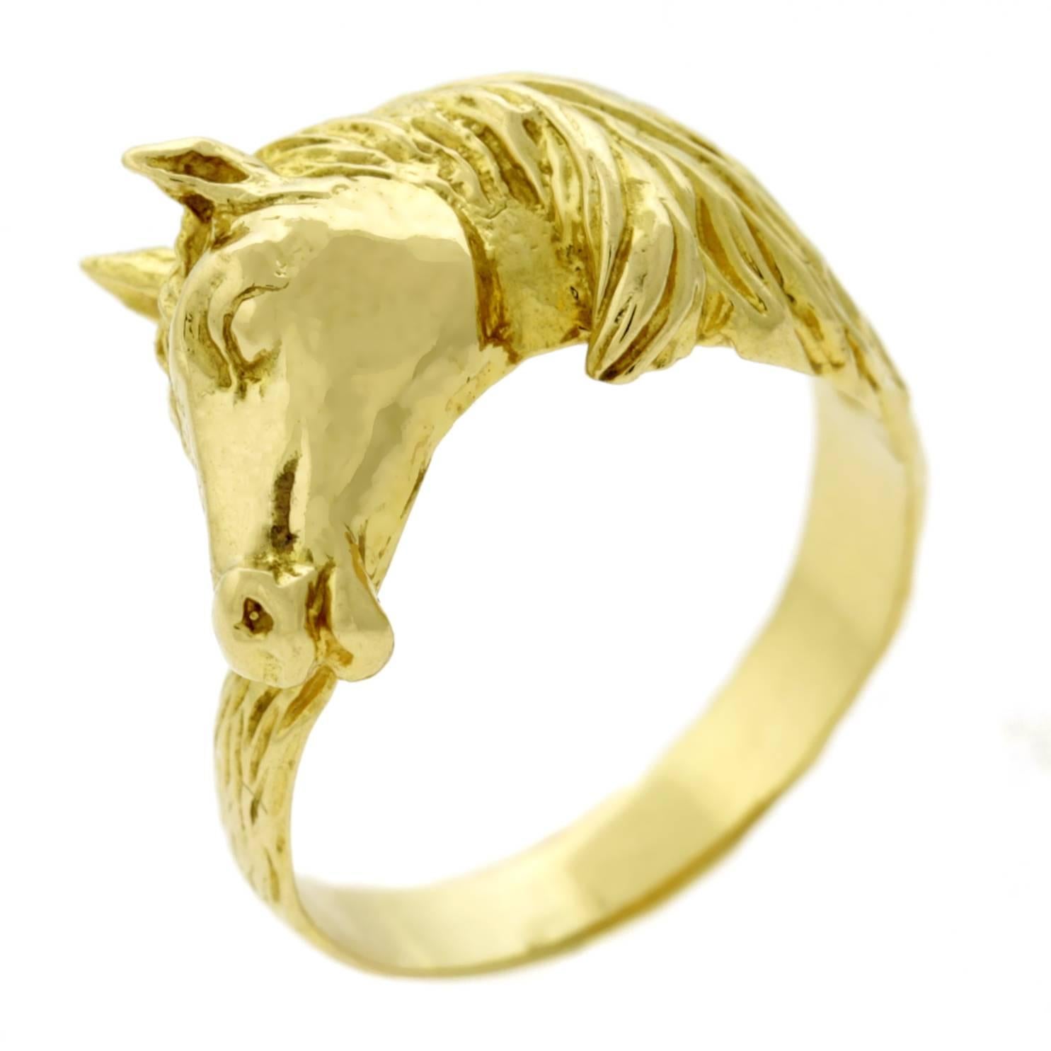A fabulous rare Hermes Paris 18k yellow gold ring depicting an iconic horse head motif. The ring measures .55