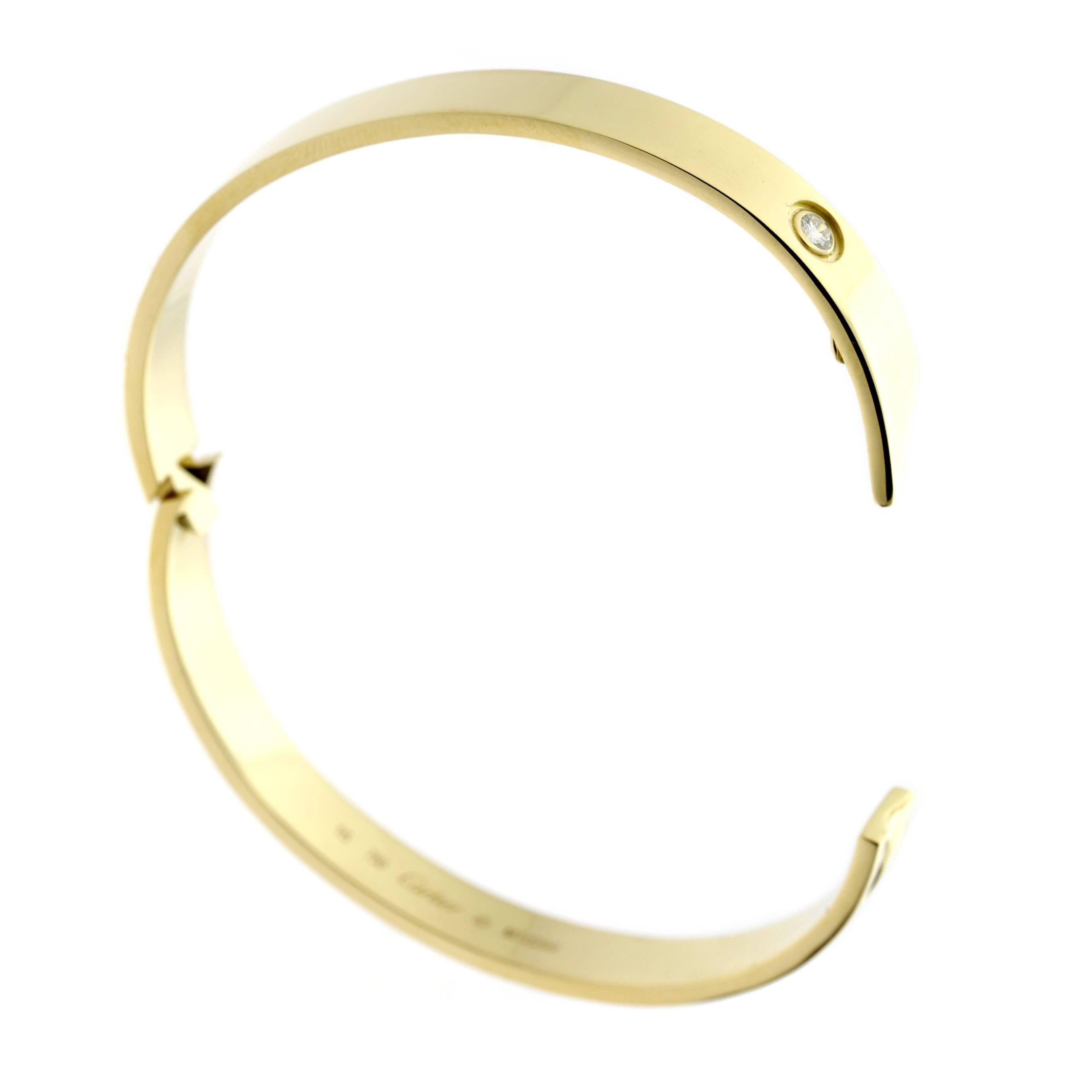 A chic 18k yellow gold Cartier diamond bangle bracelet from the late 90's, set with a .10ct round brilliant cut diamond.

Size 16