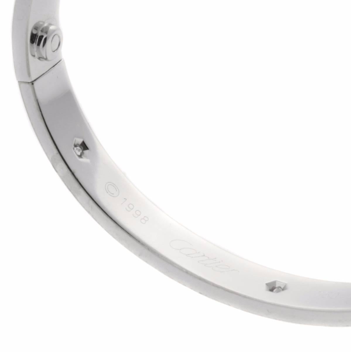 A magnificent authentic Cartier love bangle featuring 6 of the finest Cartier round brilliant cut diamonds (.60ct) set in 18k white gold.

Cartier Retail: 13,200 + Tax