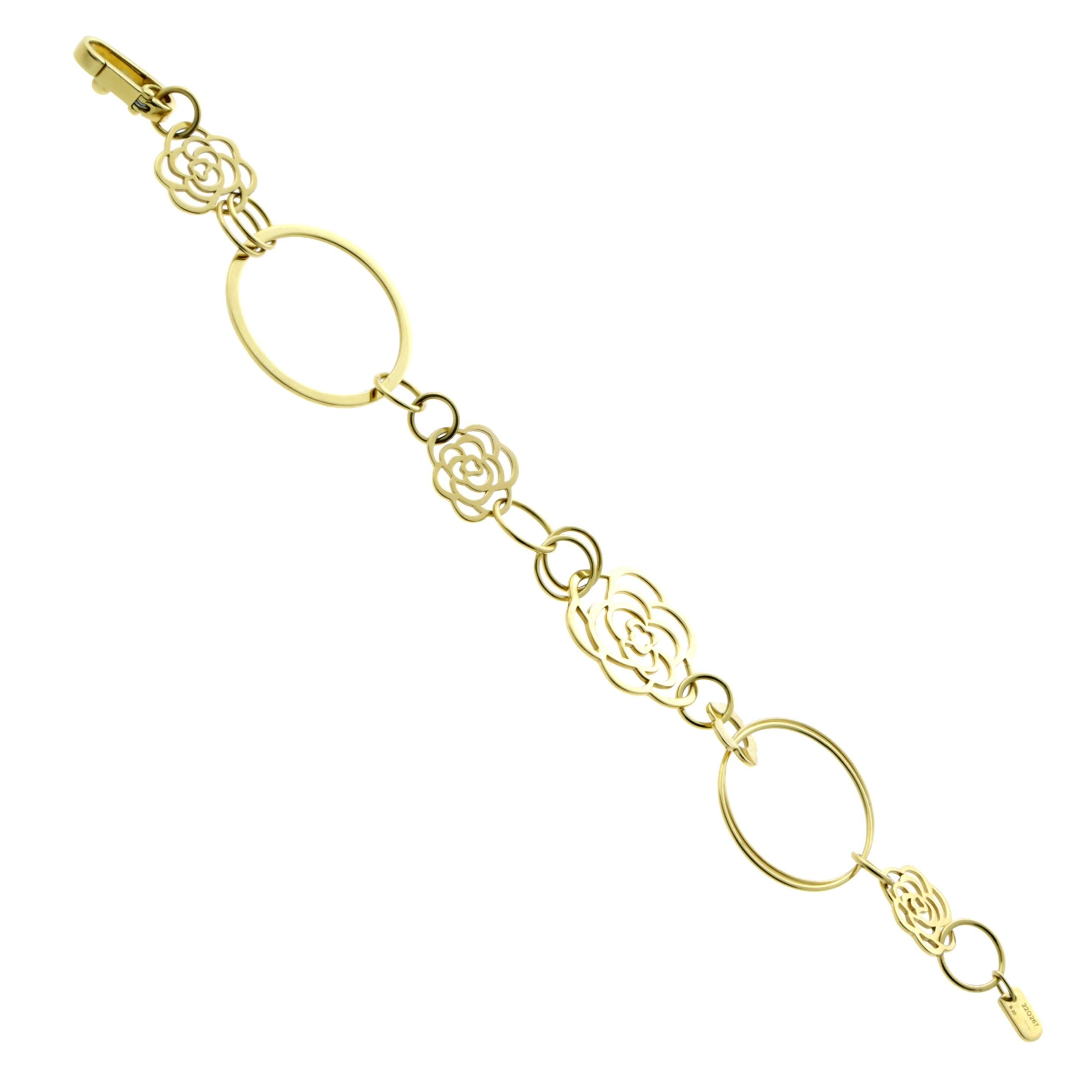A chic authentic Chanel bracelet featuring the iconic Camellia flower in various sizes set in 18k yellow gold.