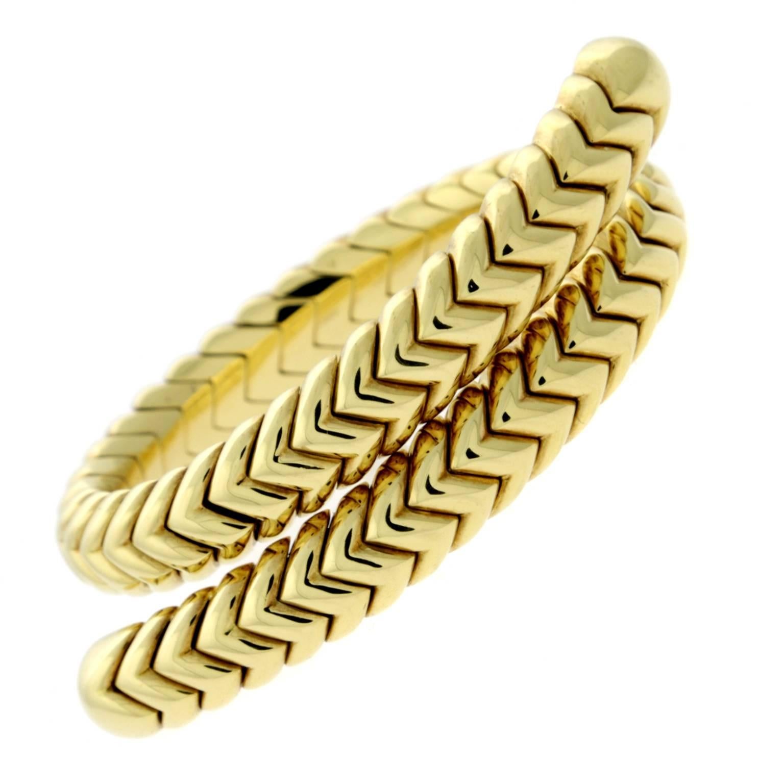 A fabulous highly collectible authentic Bulgari bracelet from the Spiga collection featuring a flexible 18k yellow gold link. Bracelet size is adjustable.