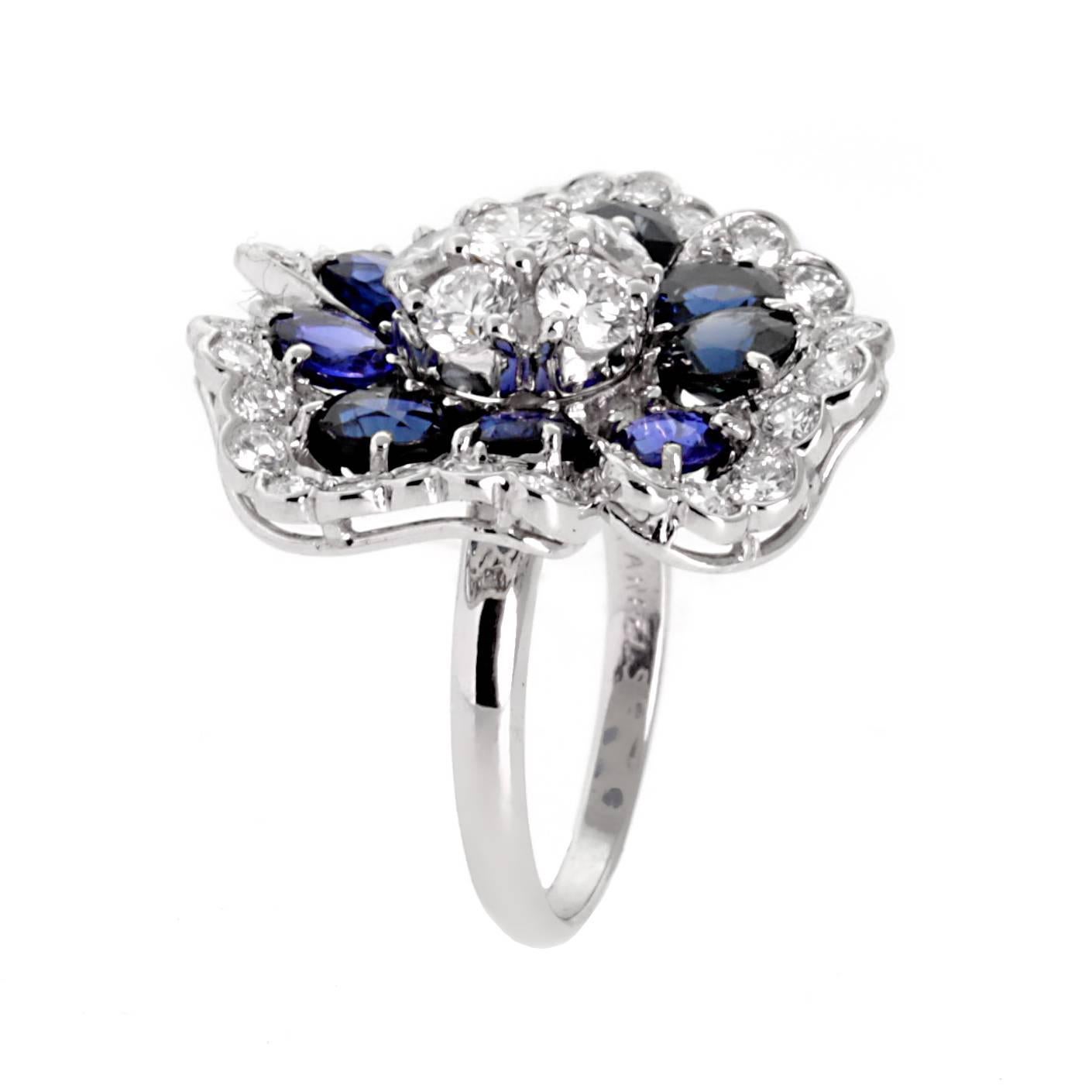 A fabulous Van Cleef & Arpels blue sapphire and diamond ring in the shape of a Camellia flower set in 18k white gold.