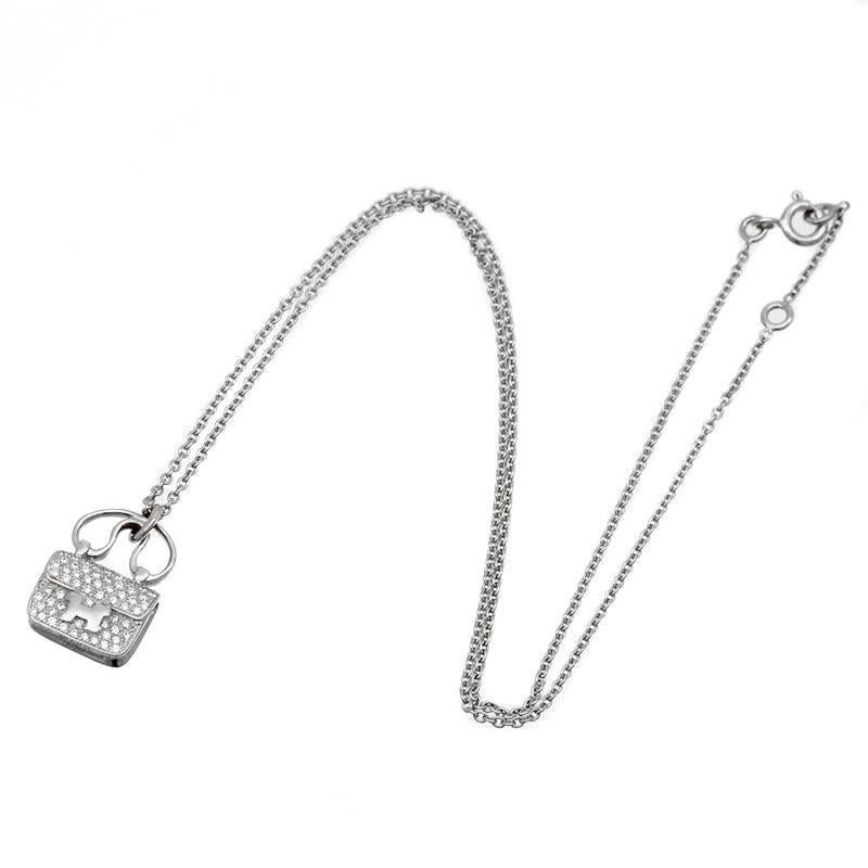 A fabulous authentic Hermes Constance charm crafted in 18k white gold featuring 65 of the finest Hermes round brilliant cut diamonds (.29ct)

The necklace is adjustable from 15 and 15.7