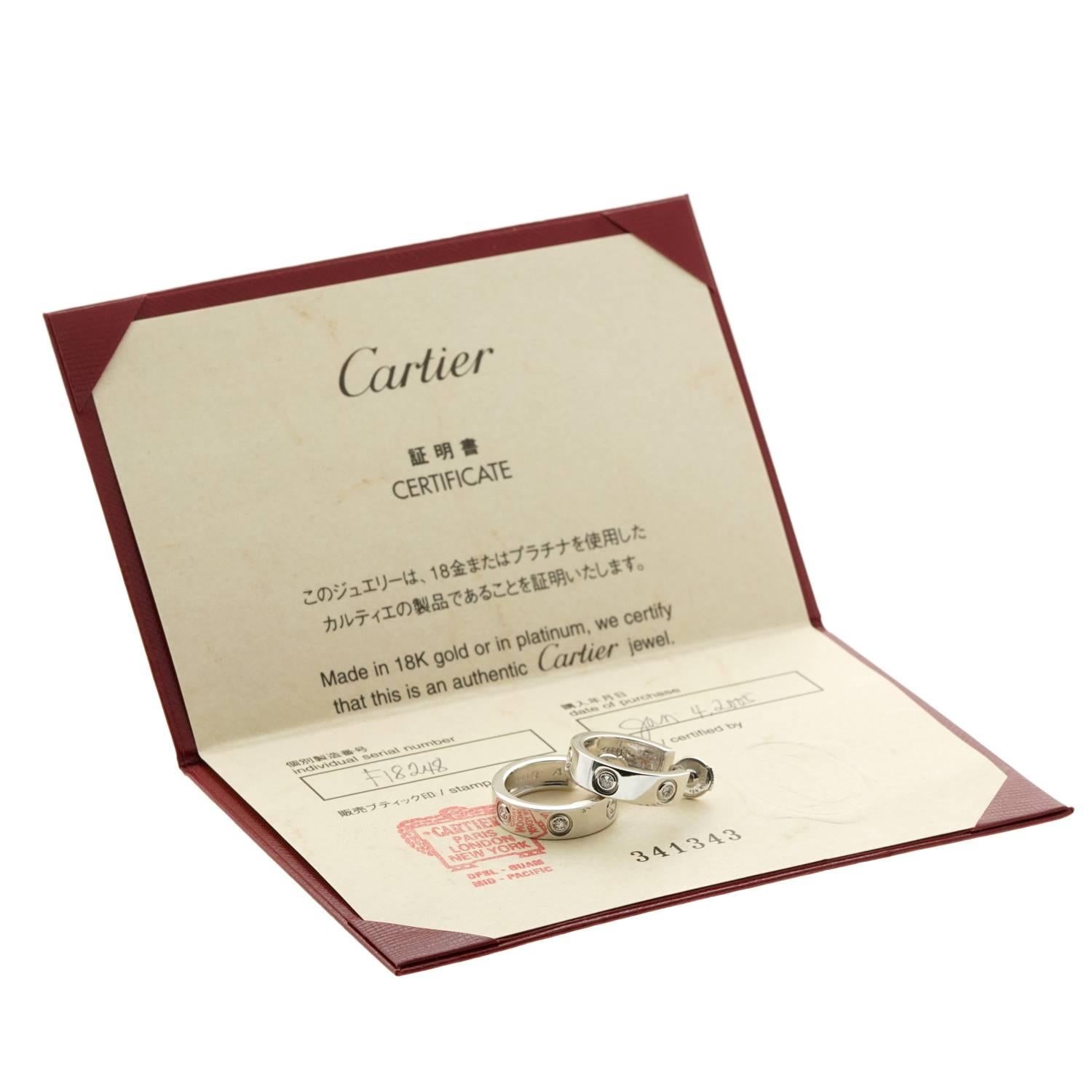 An authentic pair of timeless Cartier love diamond earrings featuring 6 round brilliant cut diamonds in 18k white gold. The earrings are for pierced ears and measure 3/4