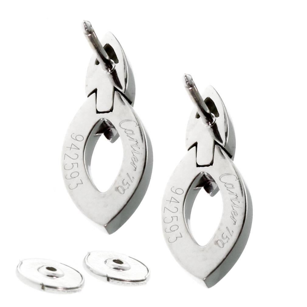 A chic pair of authentic Cartier earrings featuring 6 of the finest Cartier round brilliant cut diamonds set in shimmering 18k white gold. The earrings measures .33