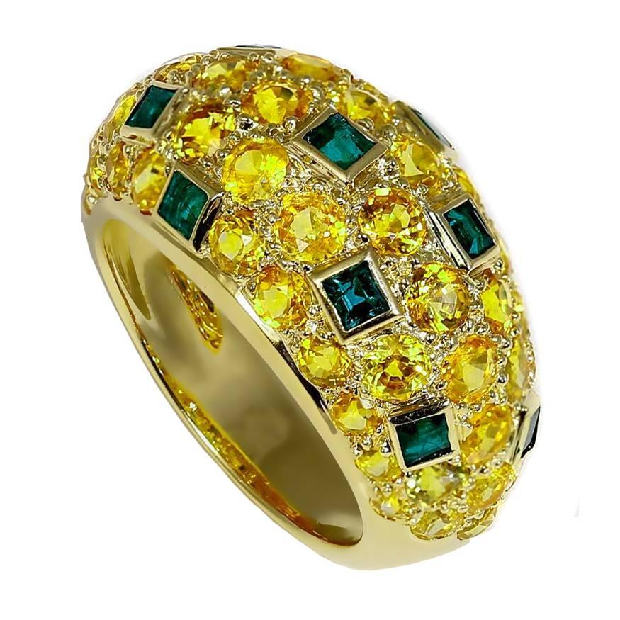 Vibrant yellow sapphires and deep green emeralds come together to create this Van Cleef & Arpels 18k yellow gold dome style ring. 

Size: US Size 6 (Resizeable)

Yellow sapphires: 49 round yellow sapphires weighing appx 4.25 carats
Emeralds: 10