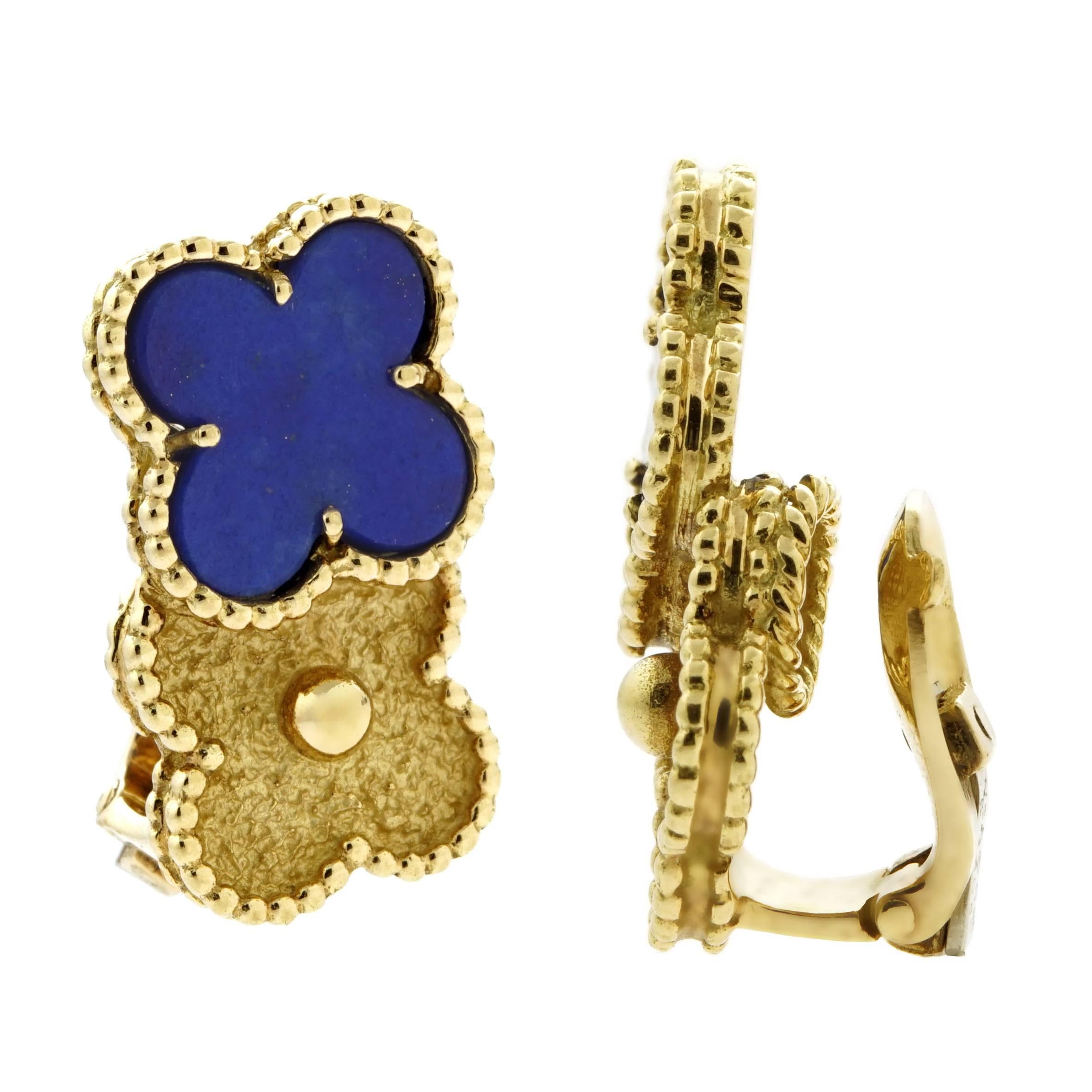 A magnificent pair of authentic Van Cleef & Arpels earrings featuring a double vintage Alhambra pattern adorned with a Lapis Luzuli stone set in shimmering 18k yellow gold, Earring Length: .90", Width: .82" 

This magnificent piece is