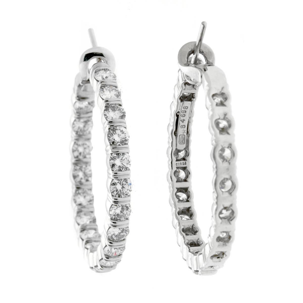 A magnificent pair of authentic Harry Winston diamond hoop earrings featuring 5.46ct of the finest Harry Winston round brilliant cut diamonds set in platinum. The earrings have a circumference of 1.25". 