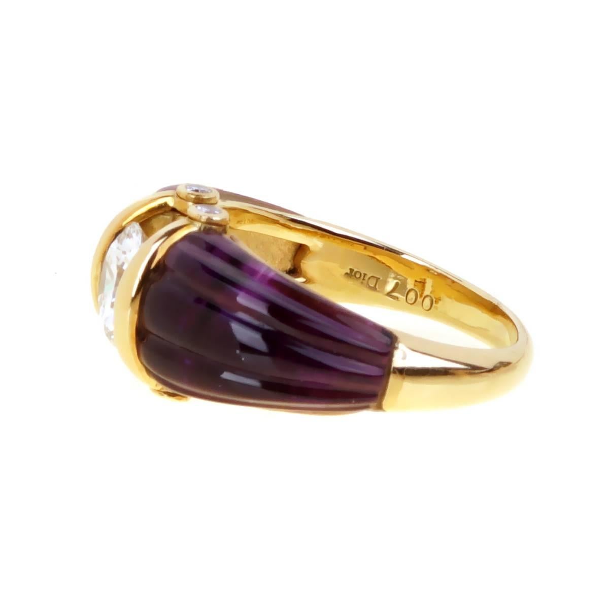 A fabulous ultra chic Dior ring featuring a 2 carved amethyst stones showcasing a 1.14ct round brilliant cut VS diamond in 18k yellow gold. The 2018 color of the year has been chosen by Pantone, Ultra Violet.  Size: 6 1/2 Resizeable

Opulent