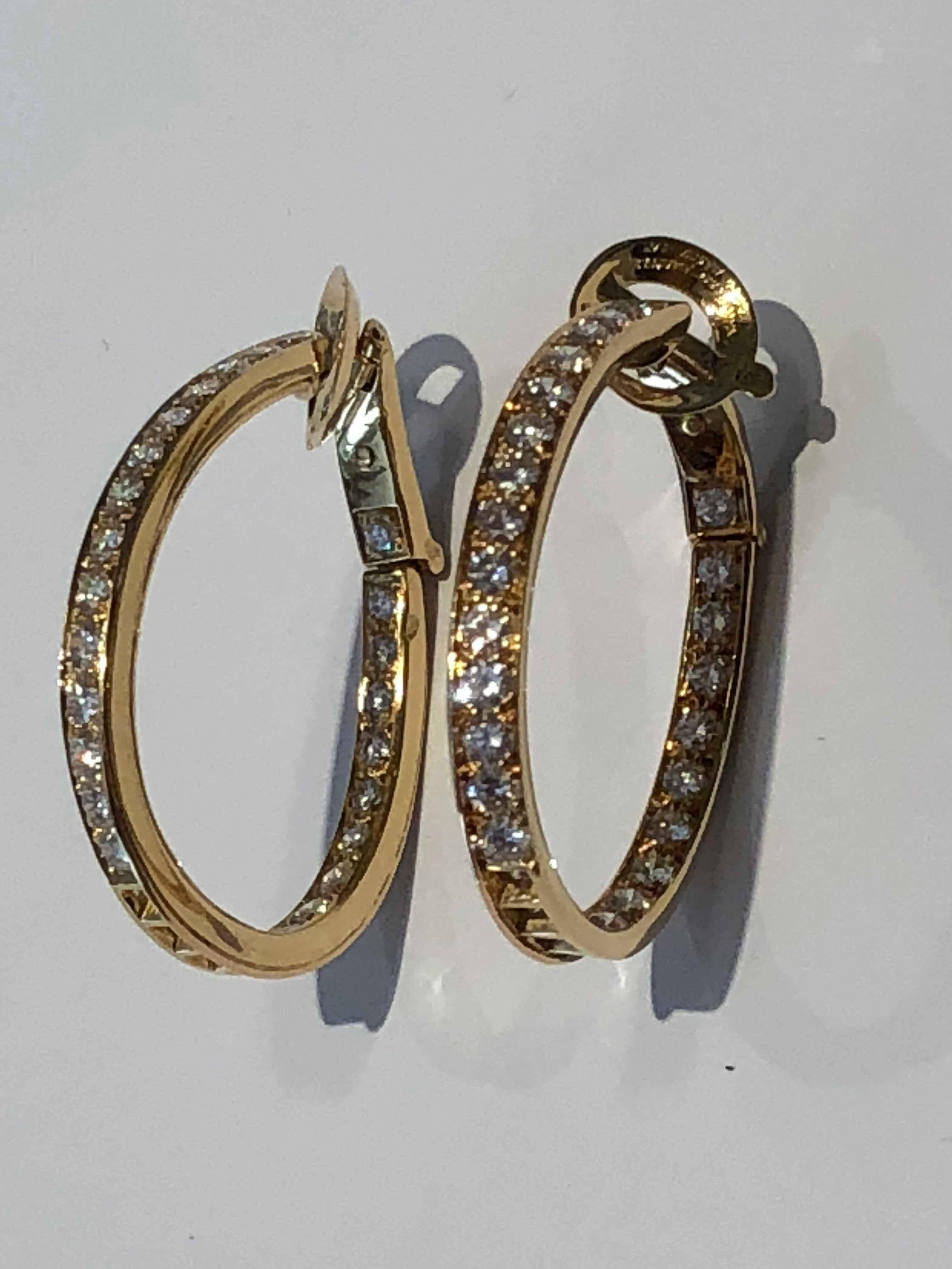 A chic pair of Van Cleef & Arpels earrings featuring an infinity design with round brilliant cut diamonds set inside and out in 18k yellow gold. Appx 3.9ct of Vs Round Brilliant Cut diamonds.