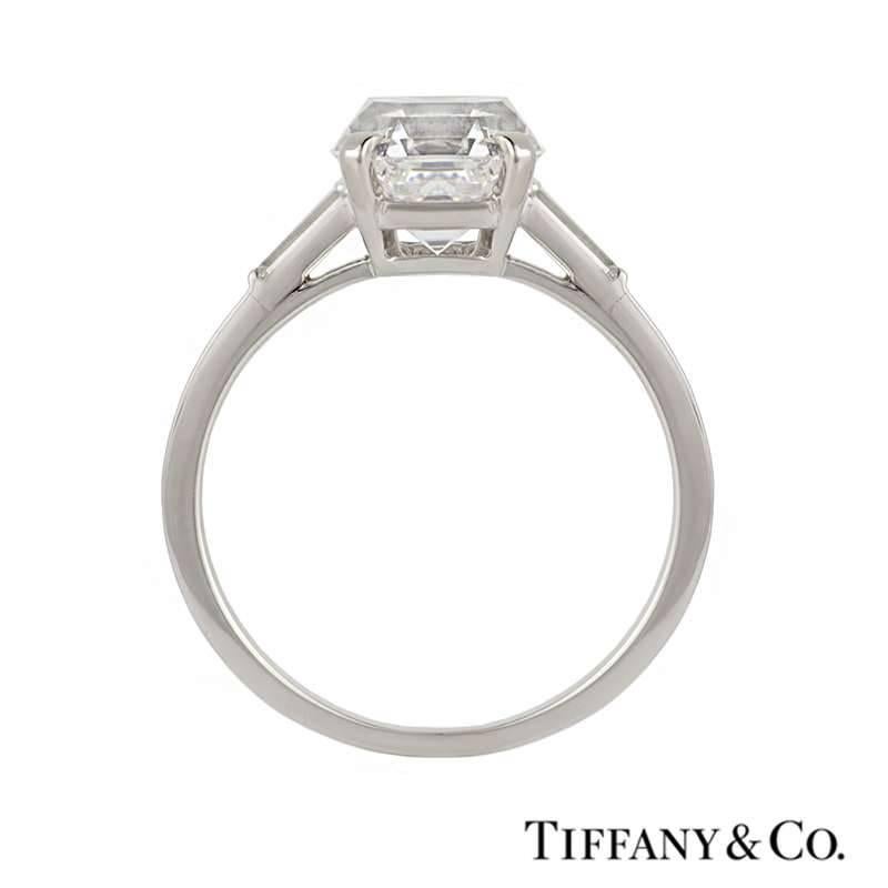 An exquisite diamond ring by Tiffany & Co set in palladium from the 1940s. The central claw set emerald cut diamond weighs 3.48ct, is E colour and VVS2 in clarity and is set between two baguette cut diamonds totalling approximately 0.40ct, well