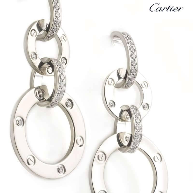 A signature pair of 18k white gold Love earrings from Cartier. Each earring consists of 2 circular disks displaying both the classic screw motif and round brilliant cut diamonds which are interlinked by 2 diamond set links with 76 diamonds in total.