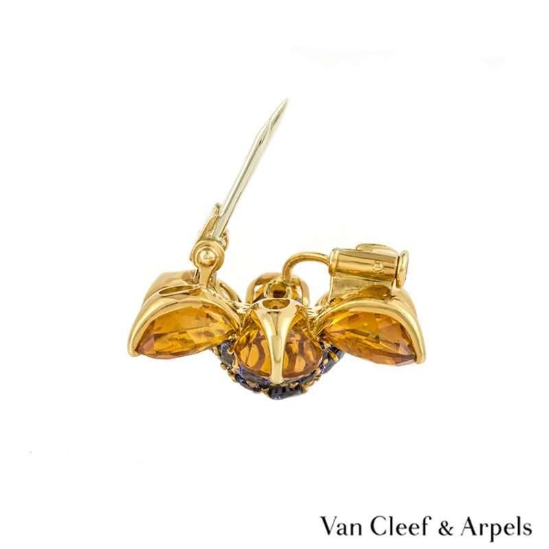 A beautiful blue sapphire and citrine floral pendant/brooch from the Van Cleef & Arpels Hawaii collection. The brooch is set to the centre with 20 graduating round blue sapphires in a pave setting totalling approximately 1.00ct, complemented by