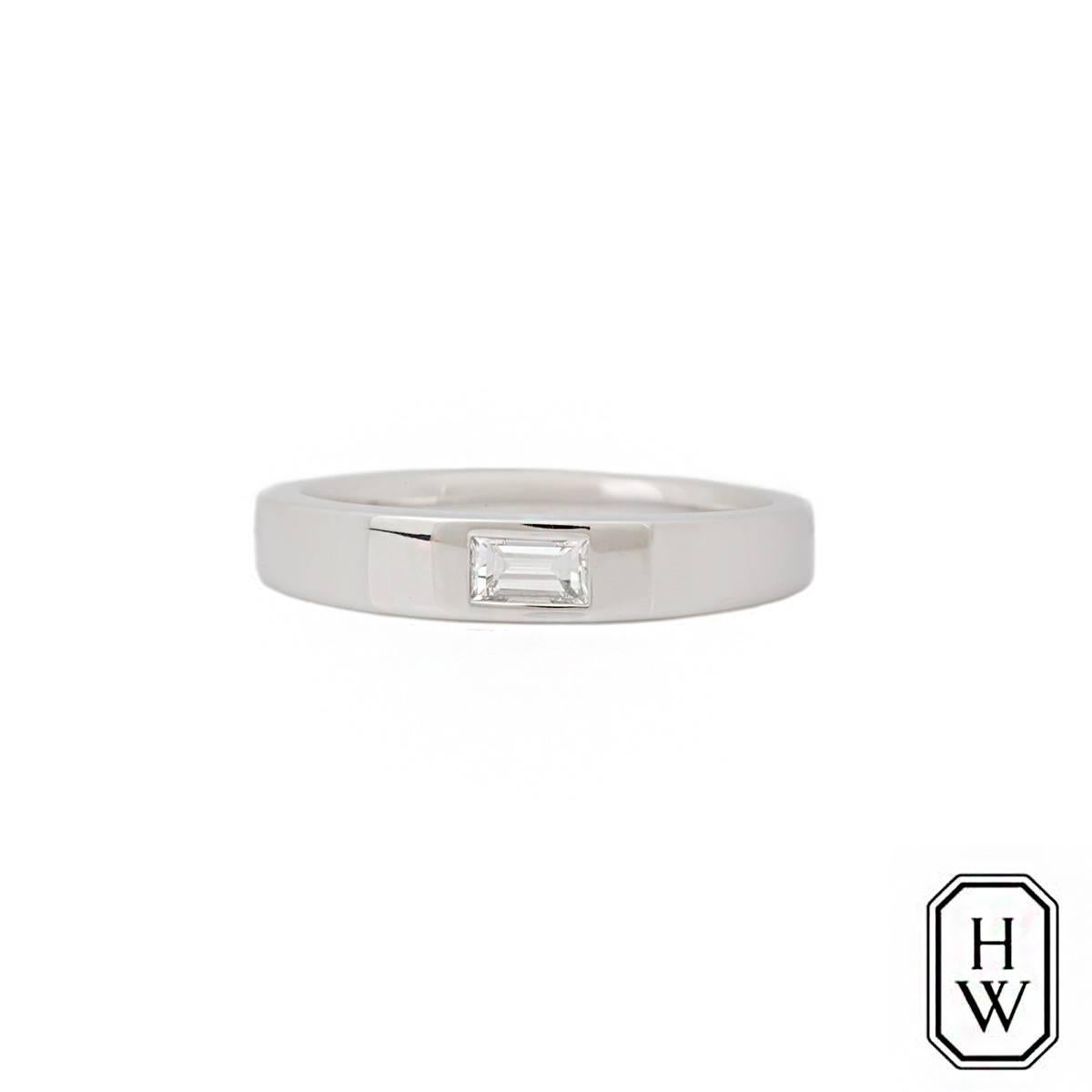 A diamond set band in platinum by Harry Winston. The band is set to the centre with a single baguette cut diamond weighing 0.21ct, F colour and VVS2 clarity. The tapered band measures 4mm at the widest point and is currently a size O½ but can be