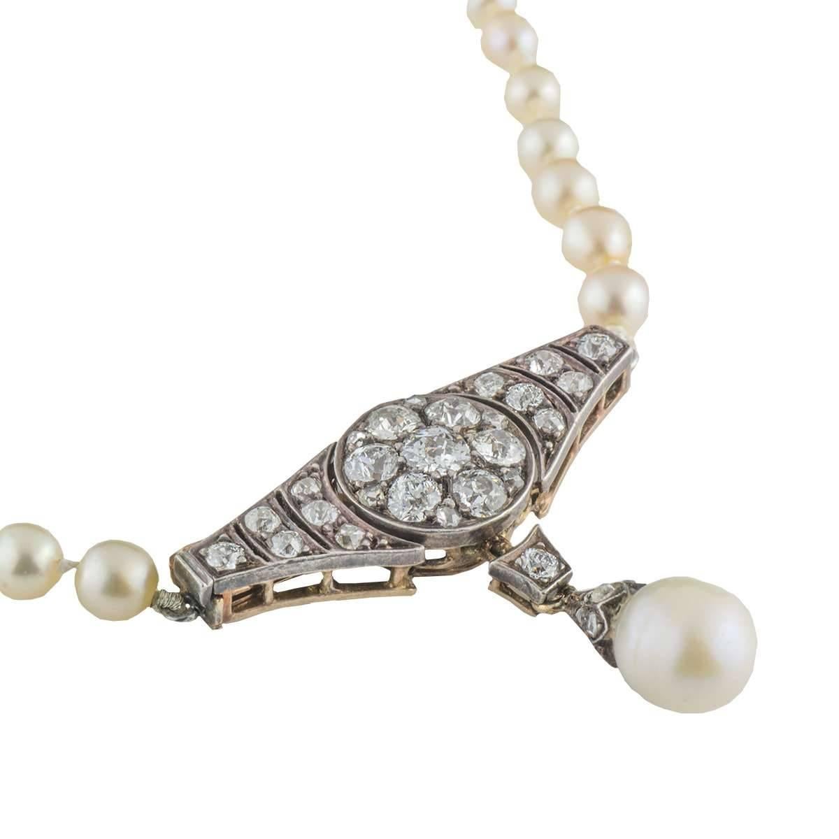 A beautiful natural pearl and diamond necklace from the early 20th century. The necklace consists of a rose gold and silver marquise link set horizontally with old cut diamonds, suspending a single diamond set link and a 7mm pearl. The diamonds are