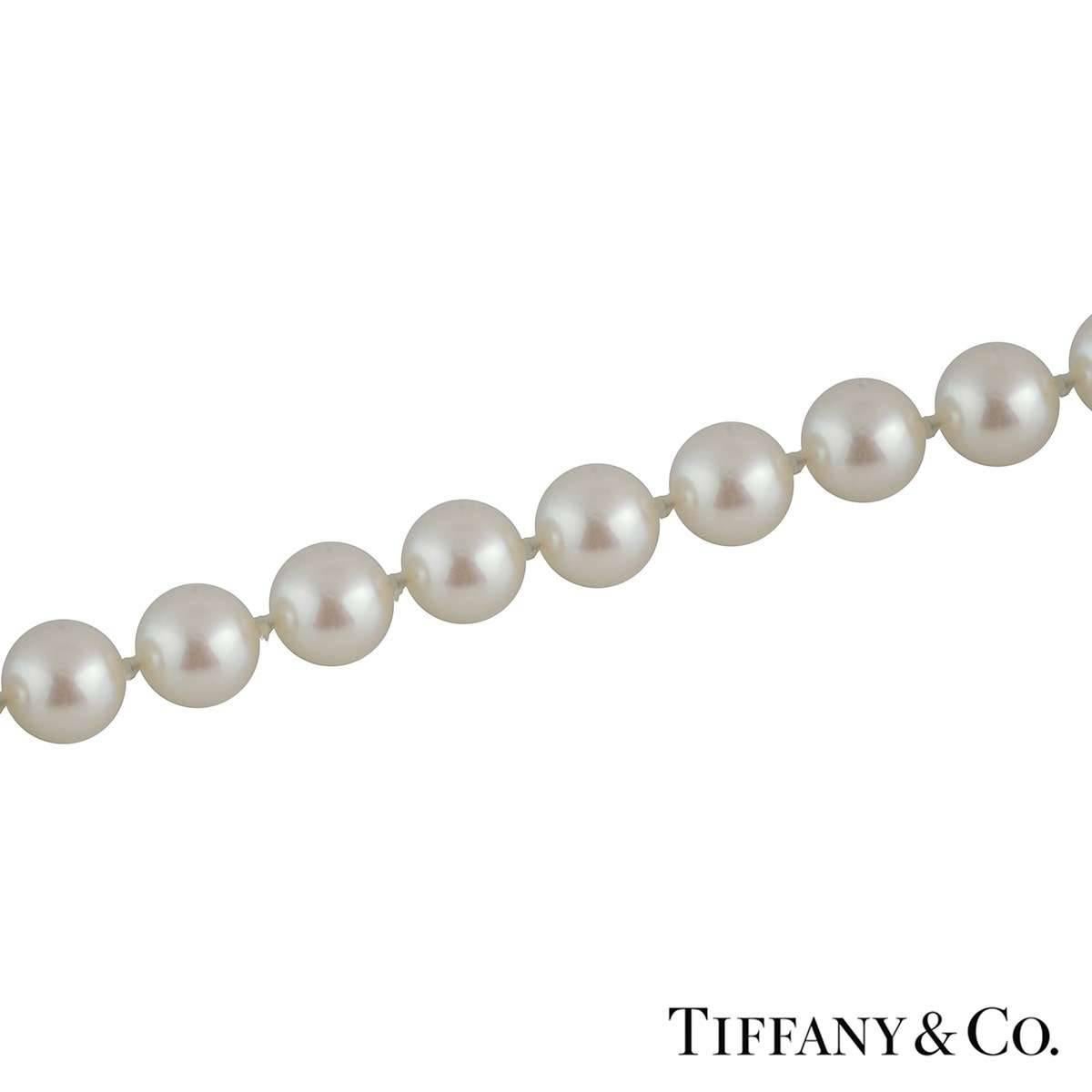 A timeless Tiffany & Co pearl necklace from the Tiffany Signature collection. The necklace features 56 individually knotted pearls each measuring 6.6-7mm with a box double-sided 'X' clasp in yellow gold. The necklace measures 16 inches in length and