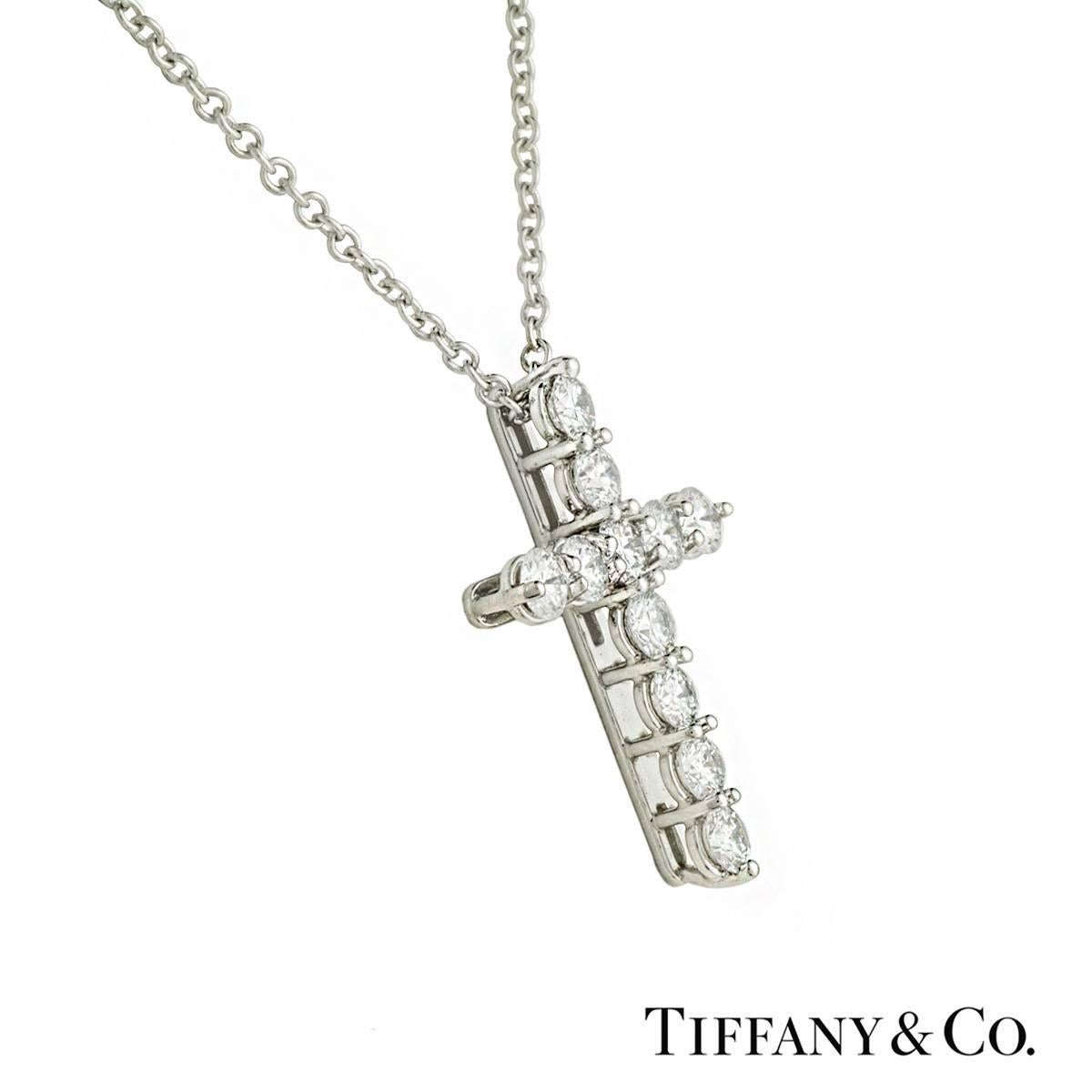 A beautiful diamond set cross pendant in platinum by Tiffany & Co. The cross is set with 11 round brilliant cut claw set diamonds totalling approximately 0.45ct. The pendant measures 1.3cm X 1.8cm and comes on an original 16 inch Tiffany &