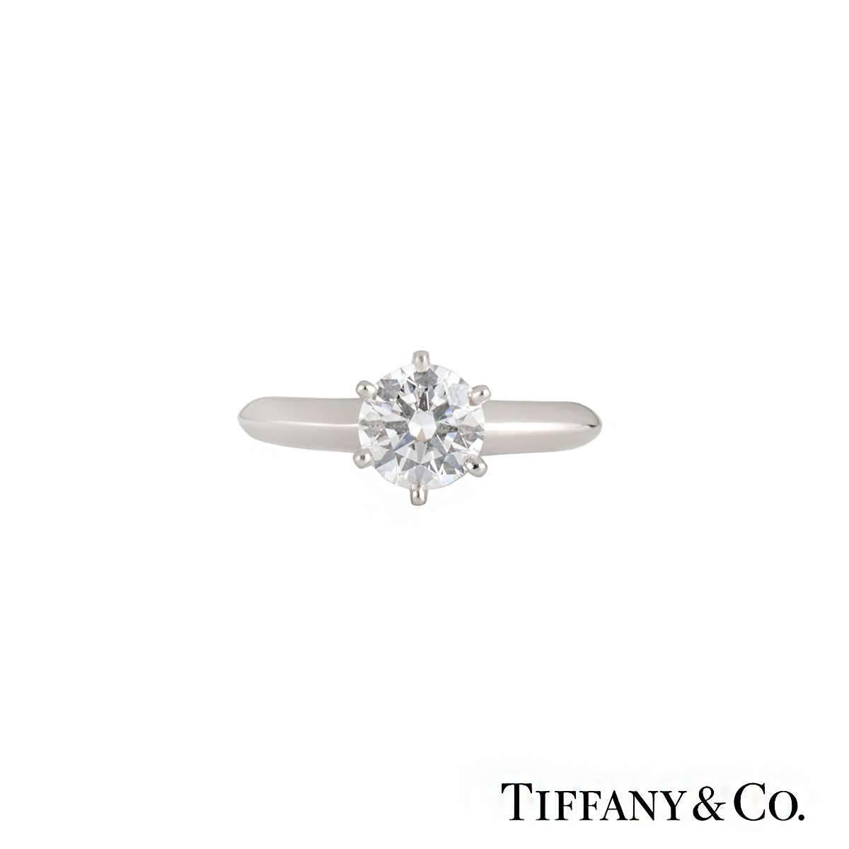 A beautiful single solitaire diamond ring by Tiffany & Co in platinum. The ring has a 6 claw setting to the centre with a round brilliant cut diamond weighing 1.07ct, F in colour and VVS2 in clarity, with a classic Tiffany knife edge setting.