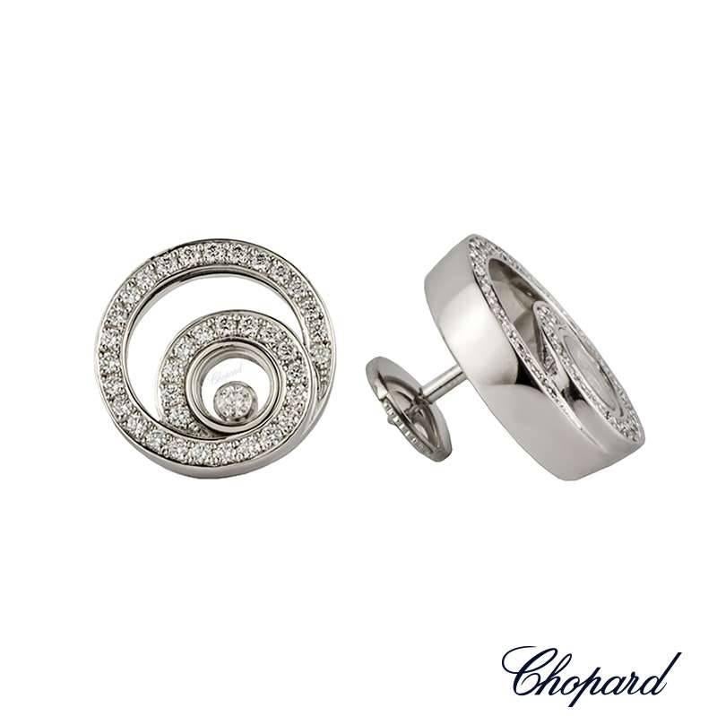 A beautiful pair of 18k white gold diamond set Happy Diamond earrings by Chopard. The earrings are composed of two entwined circular motifs set with 72 round brilliant cut diamonds totalling 0.58ct. The earrings feature an iconic floating diamond
