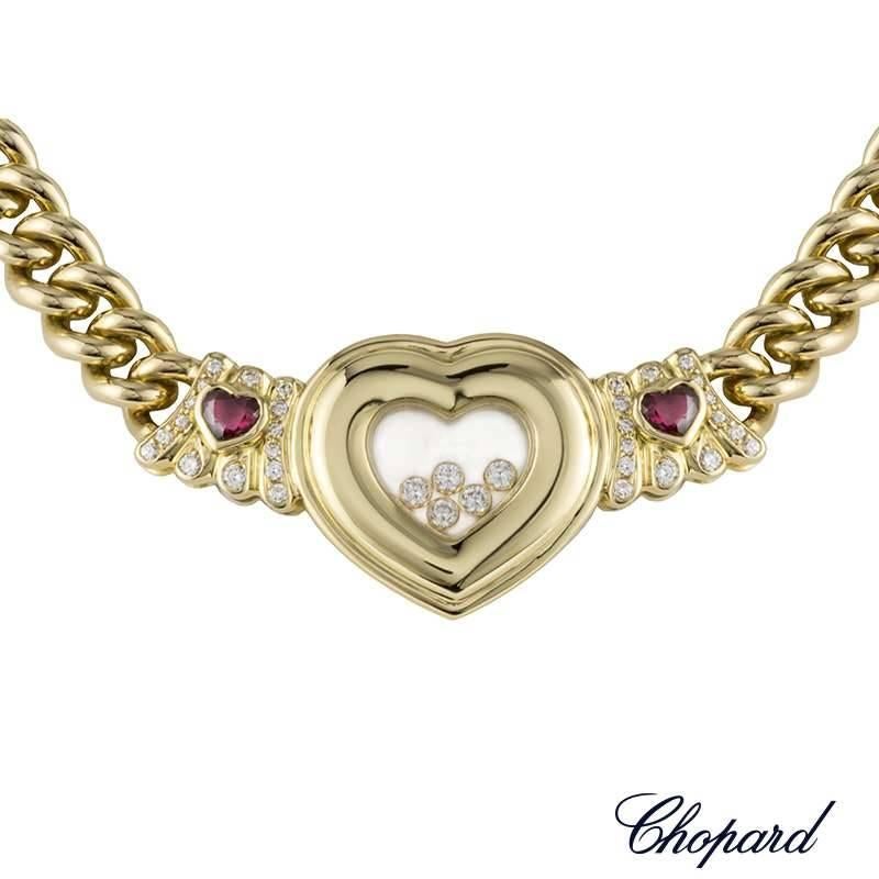 An 18k yellow gold necklace from the Chopard Happy Diamonds collection. The necklace is set to the centre with a heart motif, featuring the iconic Chopard signed glass of which encases 5 floating round brilliant cut diamonds. Accentuating the