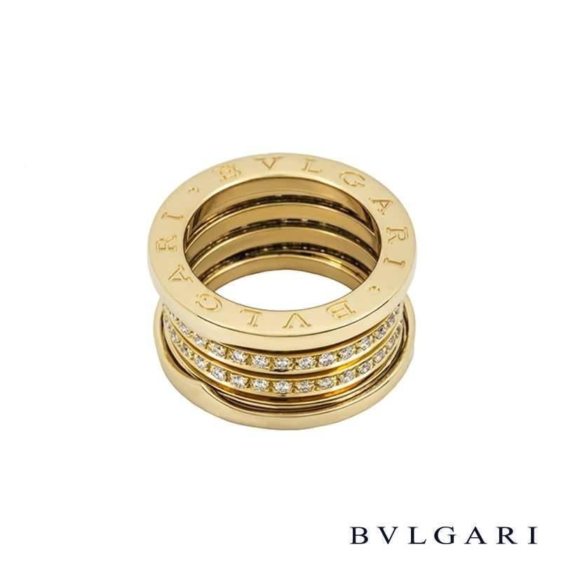 An 18k yellow gold diamond set B.zero1 ring by Bulgari. The ring is composed of signature spirals running through the centre of the band, pave set with round brilliant cut diamonds totalling approximately 0.94ct. The diamonds lead to two
