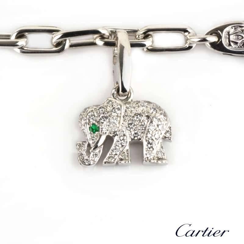 An 18k white gold open link charm bracelet by Cartier. The bracelet is made up of two 18k yellow gold charms and three 18k white gold charms. The charms consist of an 18k yellow gold rocking horse, incorporating the iconic screw motif, the other is