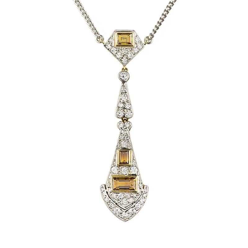 An elegant 18k white and yellow gold diamond set Art Deco necklace. The necklace comprises of an elongated flexible design of three links. The first link is of a pentagonal design consisting of pave set round brilliant cut diamonds and a single