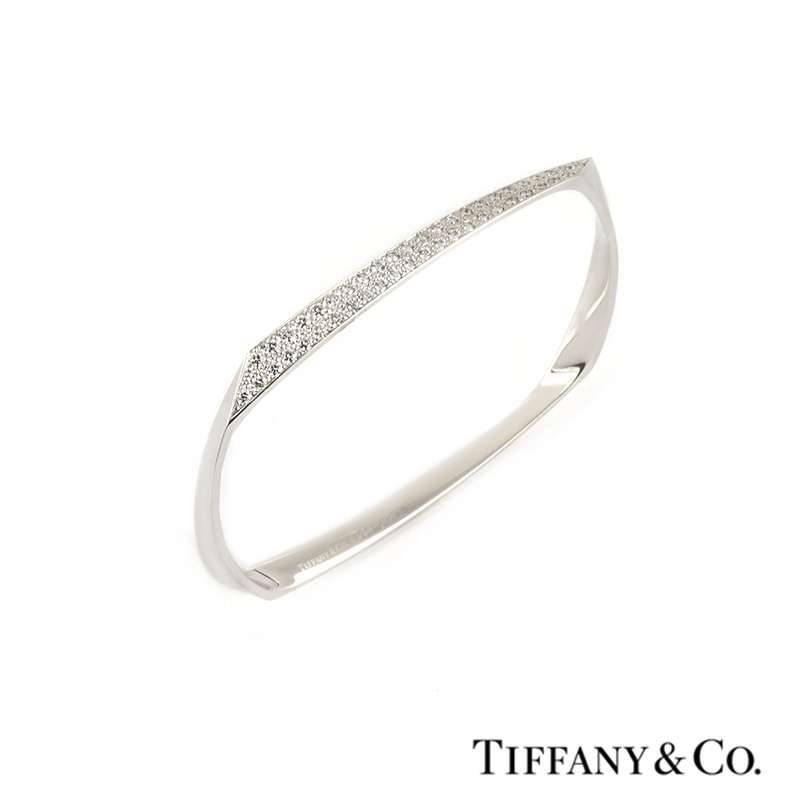 A Tiffany & Co. Frank Gehry Torque diamond set bangle in 18k white gold. Of abstract design, the bangle is set with 46 round brilliant cut diamonds totalling 1.17ct, the diamonds are F+ colour and VS clarity. The bangle measures 19cm in