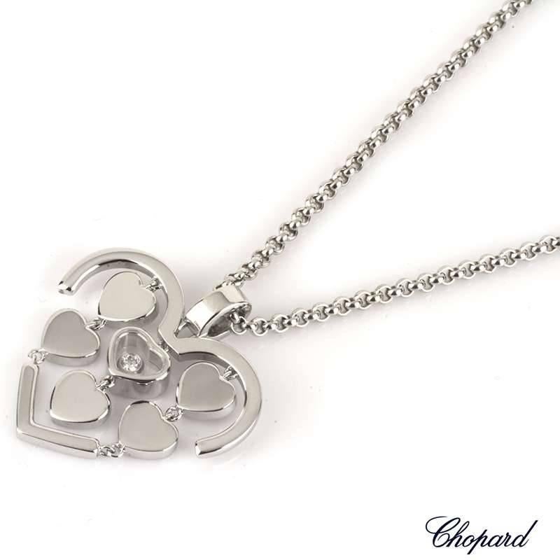 An 18k white gold Chopard Amore diamond pendant. The heart shape pendant is made up of a heart shape surround, encompassing five white gold mobile hearts and a signature floating diamond in the centre weighing 0.05ct. The pendant is on the original