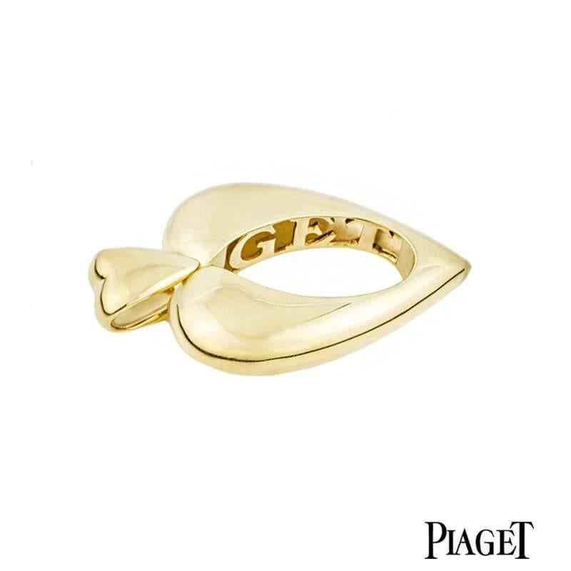 An 18k yellow gold heart pendant by Piaget. The pendant consists of a heart motif bale leading down to a larger heart with a open centre which creates the body of the pendant. On the inner edges of the heart is an open work design displaying the
