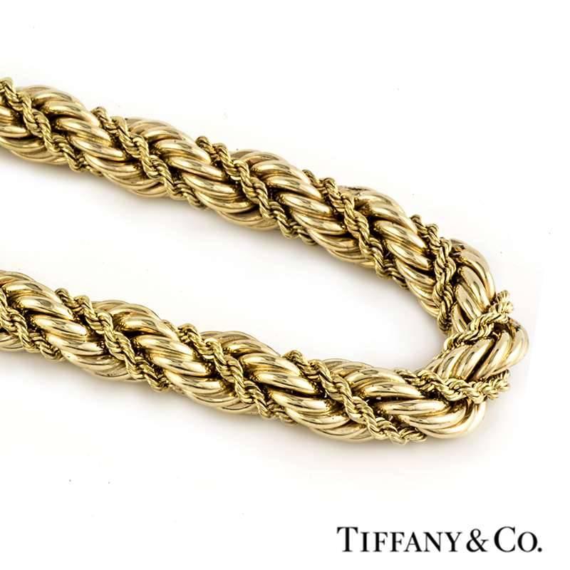 A simple 14k yellow gold necklace by Tiffany and Co. The necklace is of a rope design, approximately 7.5mm in thickness and displays a simple finer strand of twisted rope running throughout the centre. The necklace measures 16 inches in length and