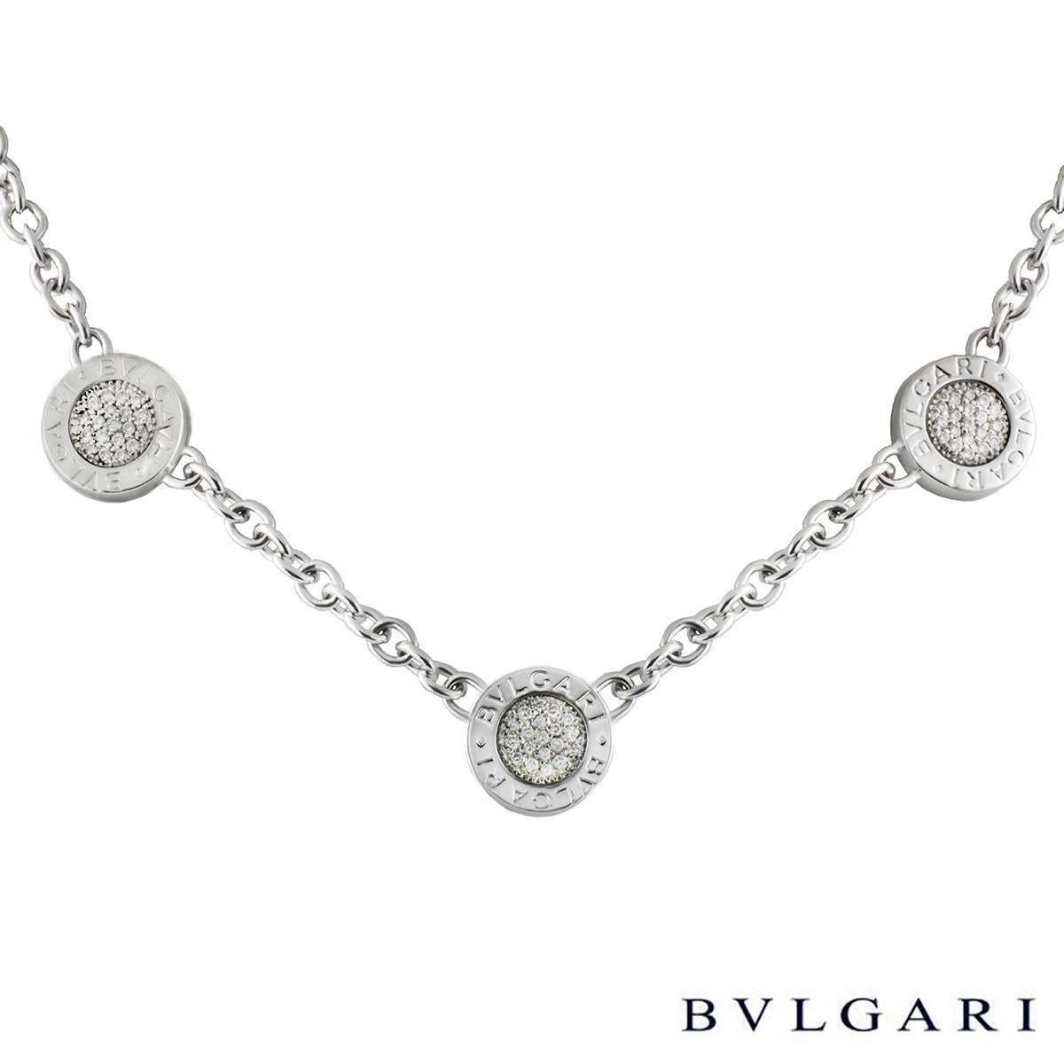 An 18k white gold Bvlgari Bvlgari necklace. The necklace is made up of 3 circular reversible disks, one side displaying a black onyx centre with the Bvlgari Bvlgari logo around the outer edge and the other has a diamond set centre. The necklace has