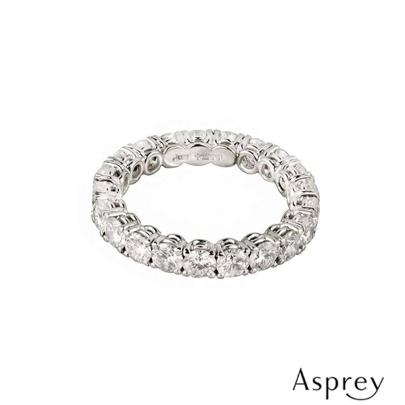 A full diamond eternity ring in platinum by Asprey. The ring is composed of 21 round brilliant cut diamonds, each individually claw set totalling approximately 2.10ct, predominantly G+ colour and SI+ in clarity. The ring measures 3mm in width and is